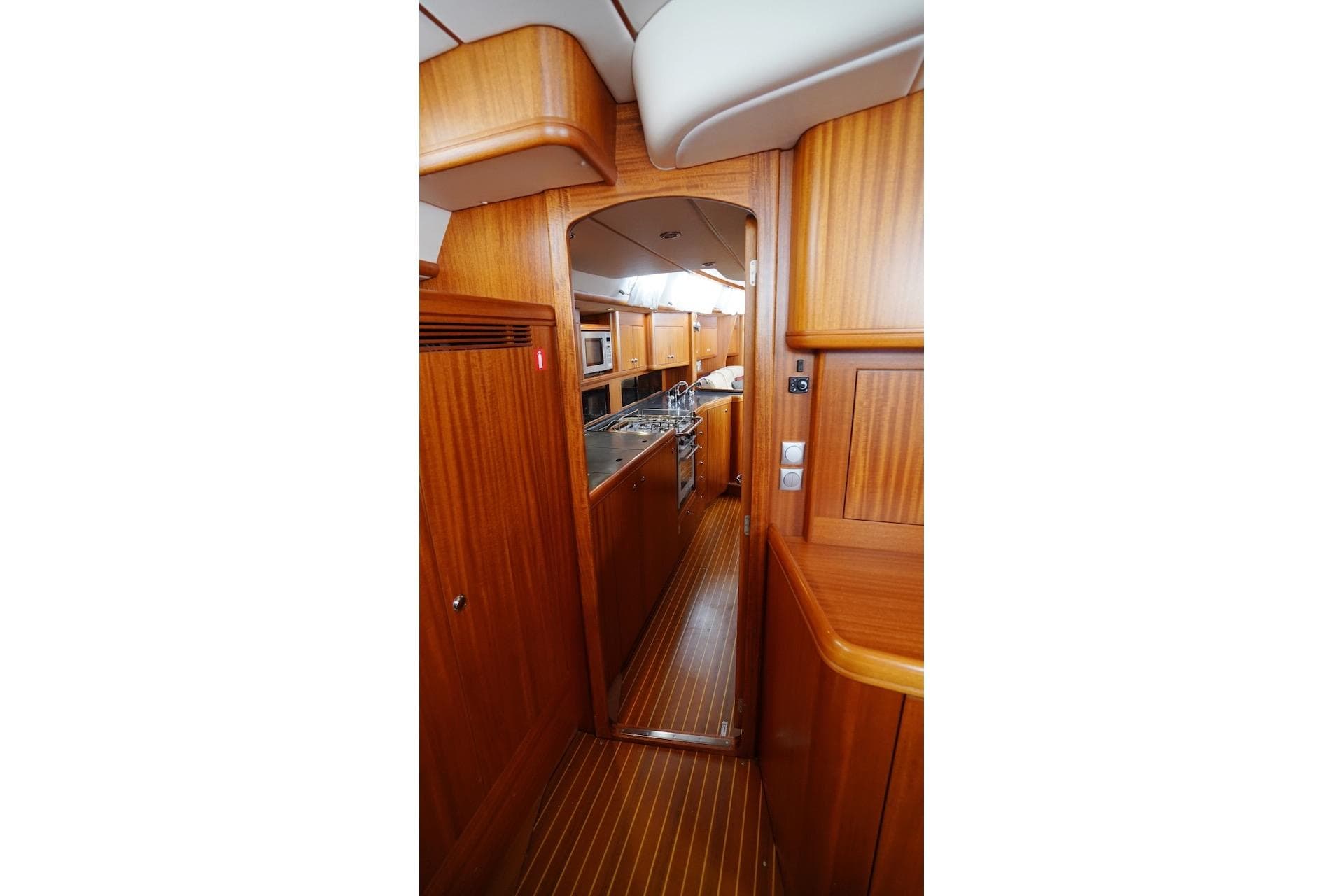 Interior of 2010 Najad 511 yacht with wooden cabinetry and modern kitchen.