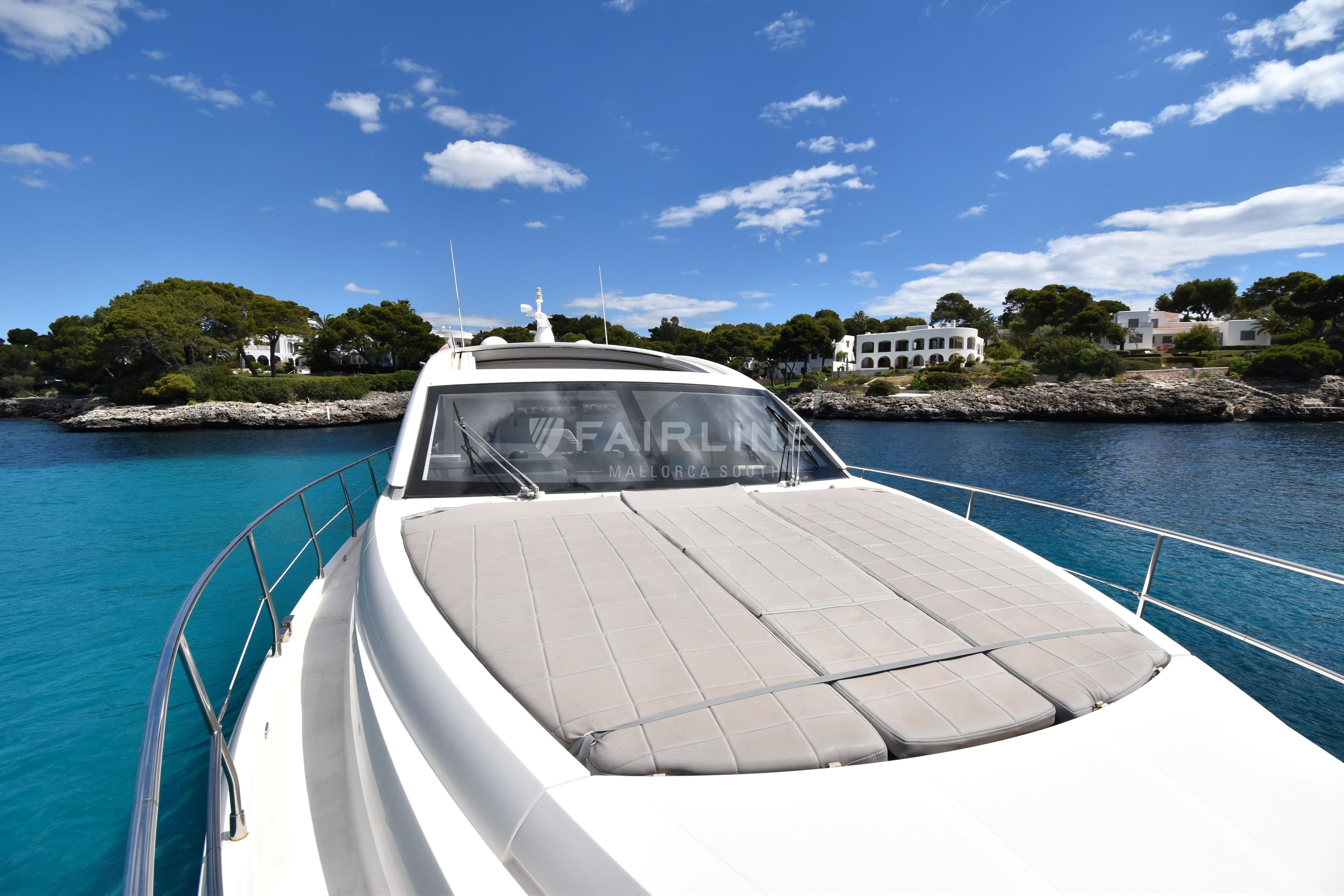 Fairline Targa 50 GT yacht cruising near scenic coastline, 2012 model.
