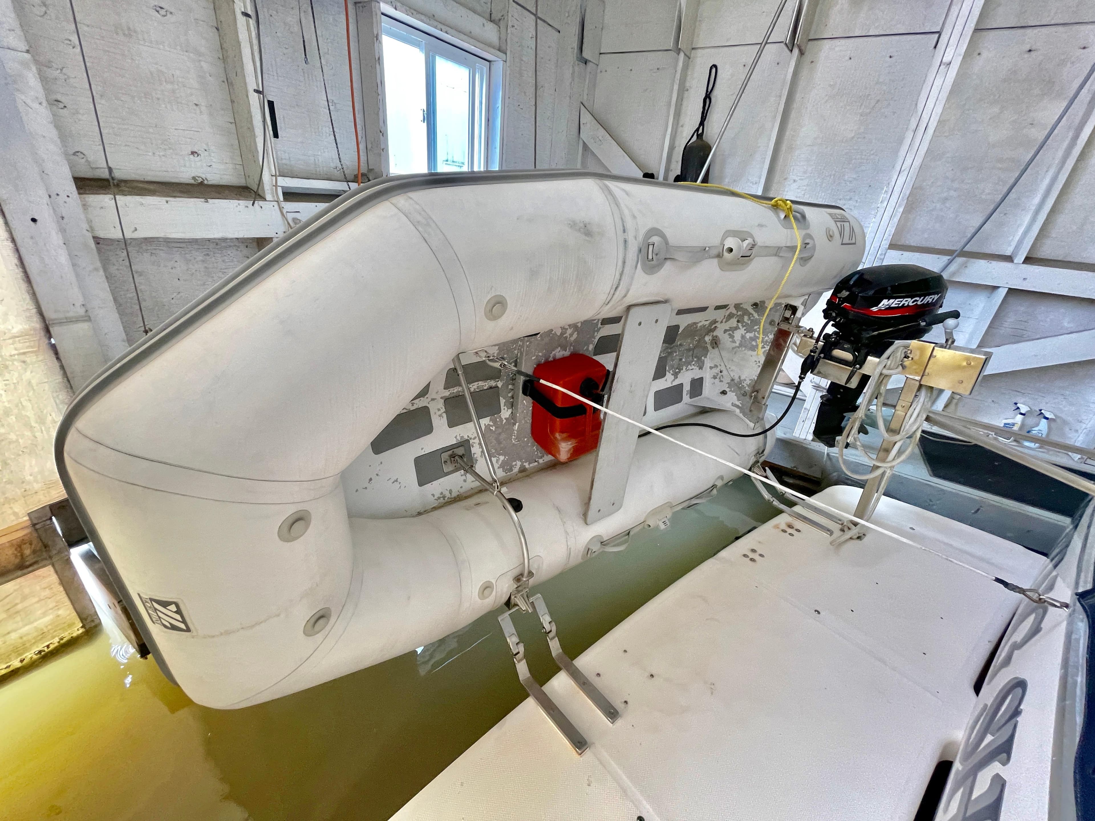 Inflatable boat on Bayliner 3988 Command Bridge Motoryacht, 1998 model, docked indoors.