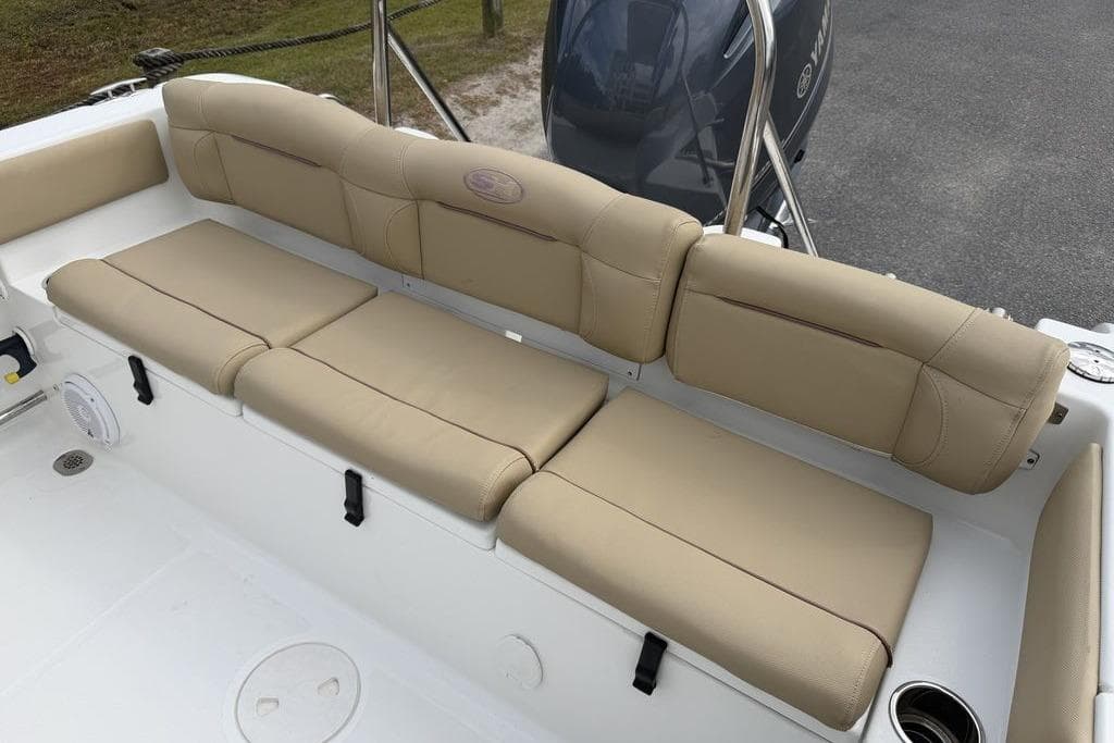 2018 Sea Hunt Ultra 225 boat with beige cushioned seating and Yamaha engine.
