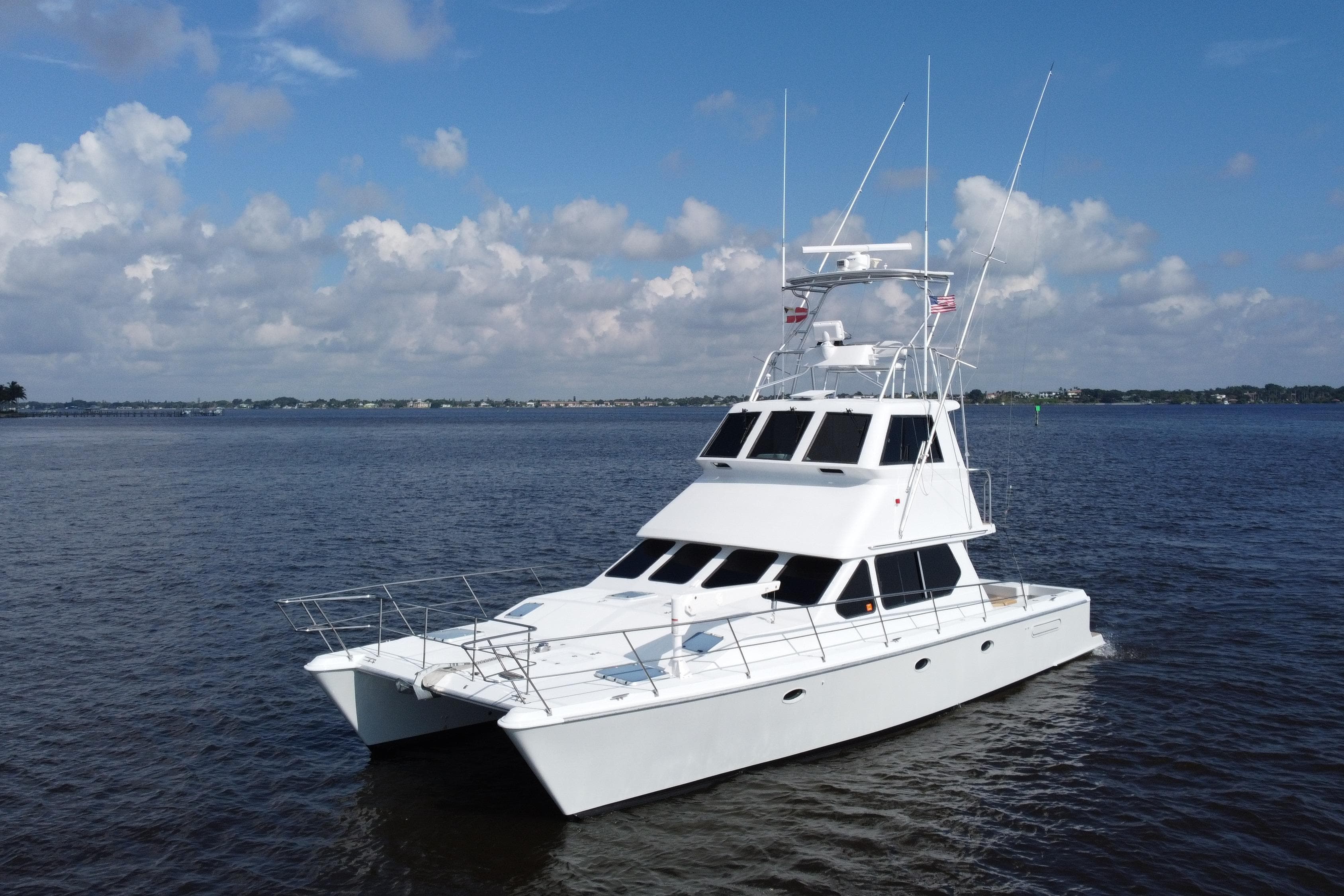 Voyager 44 yacht from 2000 on calm waters under a partly cloudy sky.