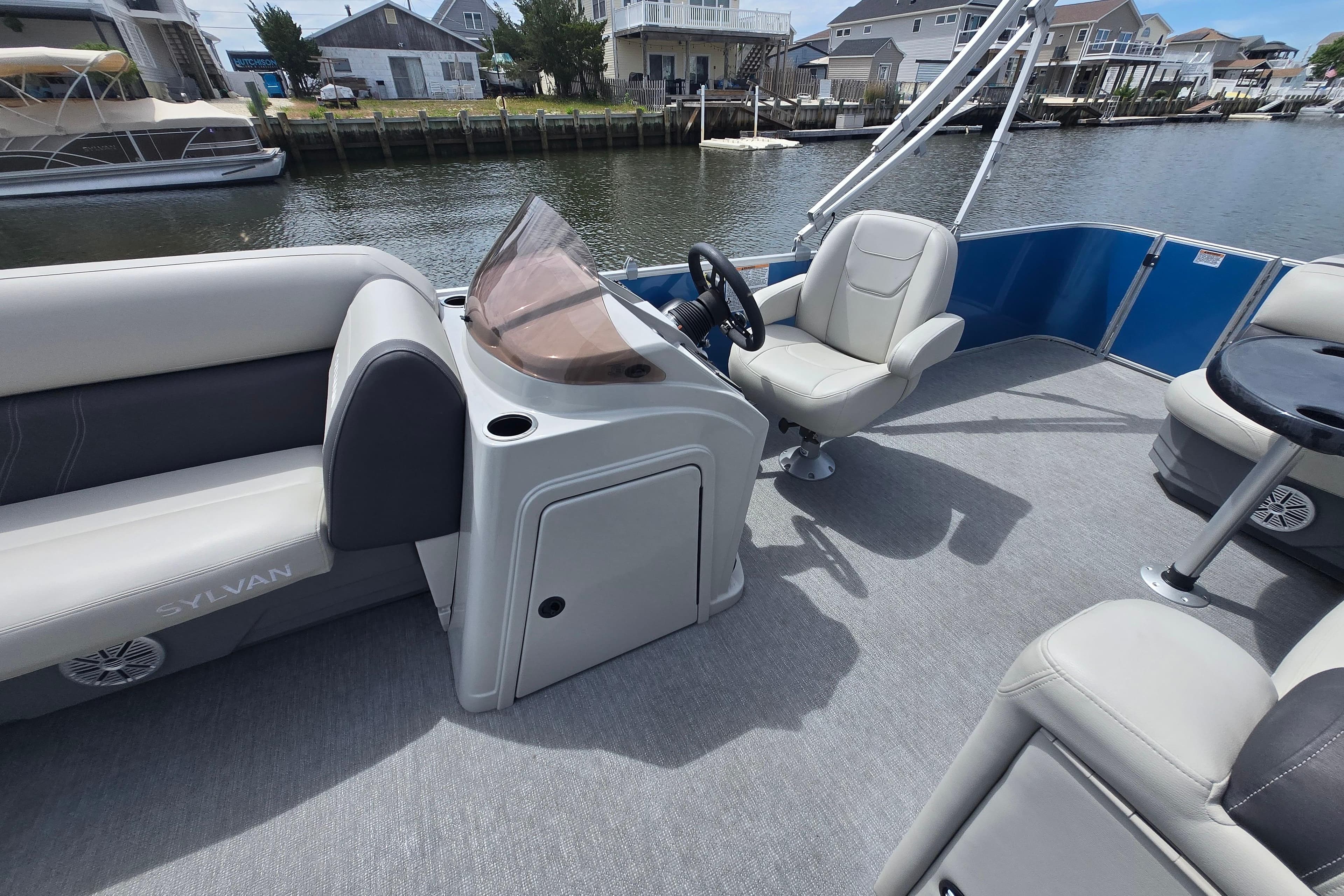 2022 Sylvan 8522 Mirage Cruise pontoon boat interior with helm and seating.