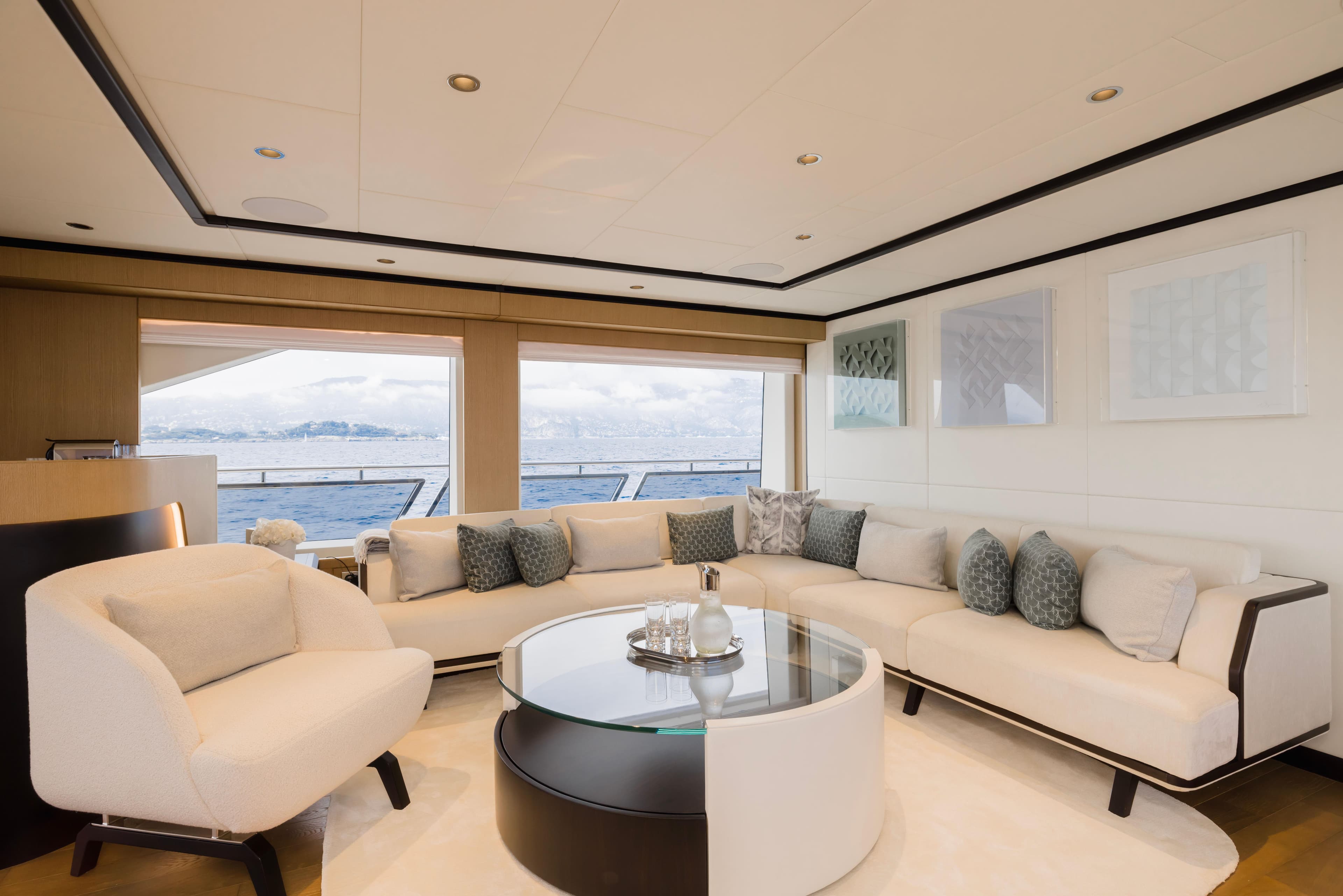 Luxurious interior of 2025 Majesty 120 yacht with elegant seating and ocean view.