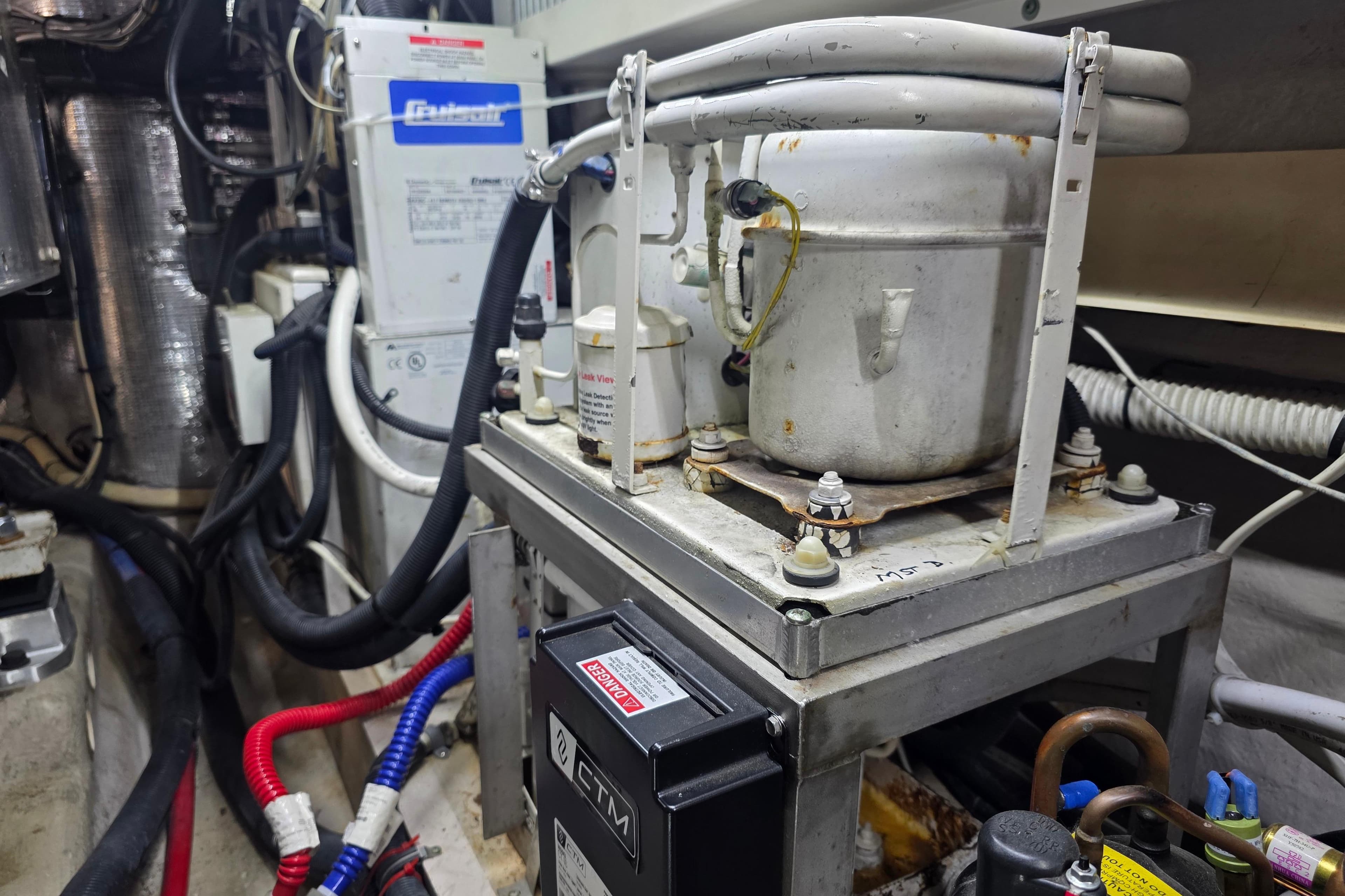 Engine room of 2002 Sea Ray 560 Sedan Bridge with mechanical equipment and wiring.
