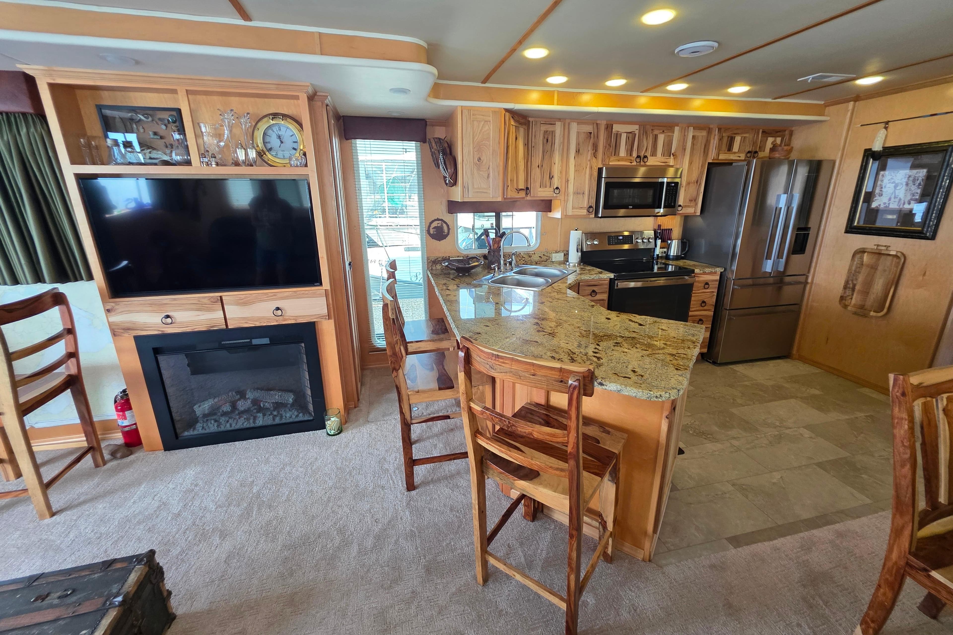 Luxurious 2015 Sailabration 64 houseboat kitchen with granite countertops and modern appliances.