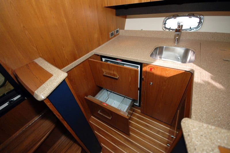 Interior of 2012 Tiara Yachts 3900 Open with kitchenette and sink.