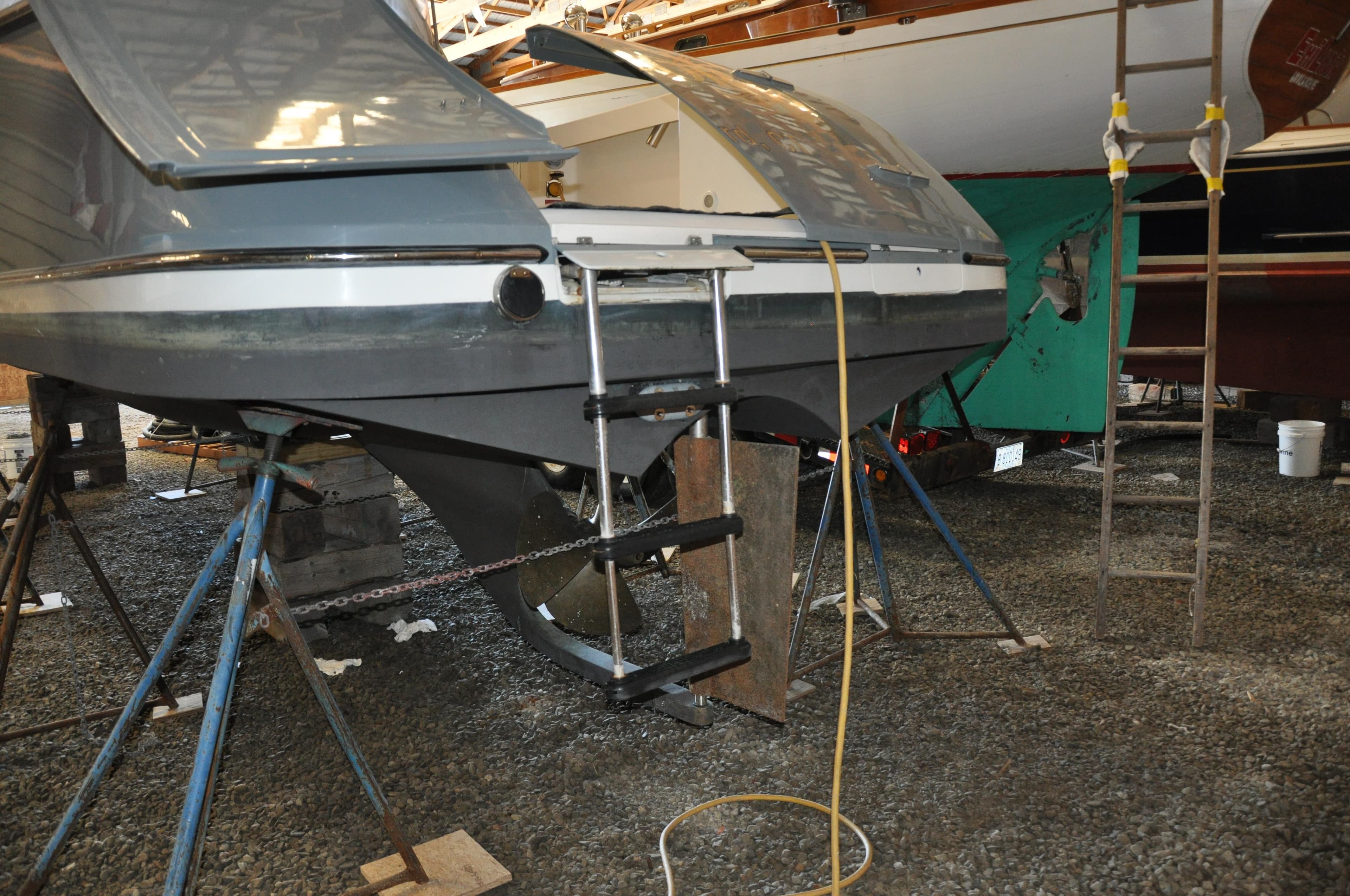 2005 True North 33 boat on stands, showing rear view with ladder and hull details.