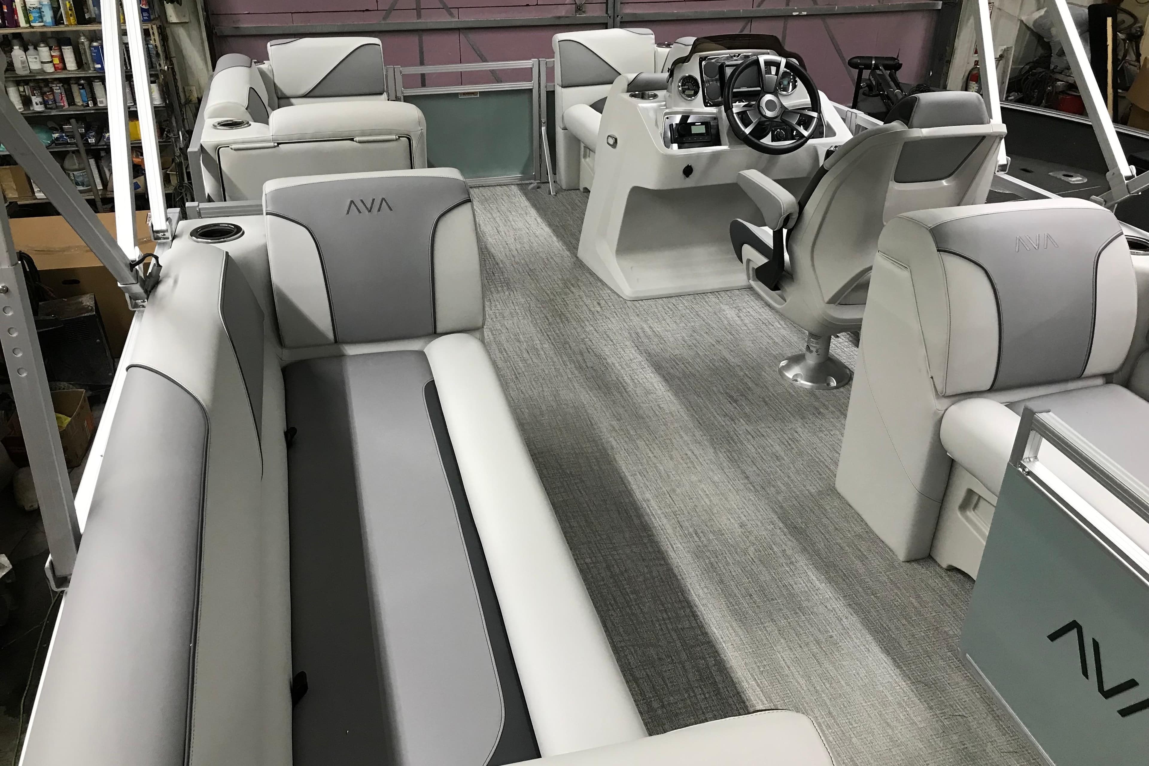 2026 Avalon Venture Quad Lounger 19' interior with modern seating and steering console.