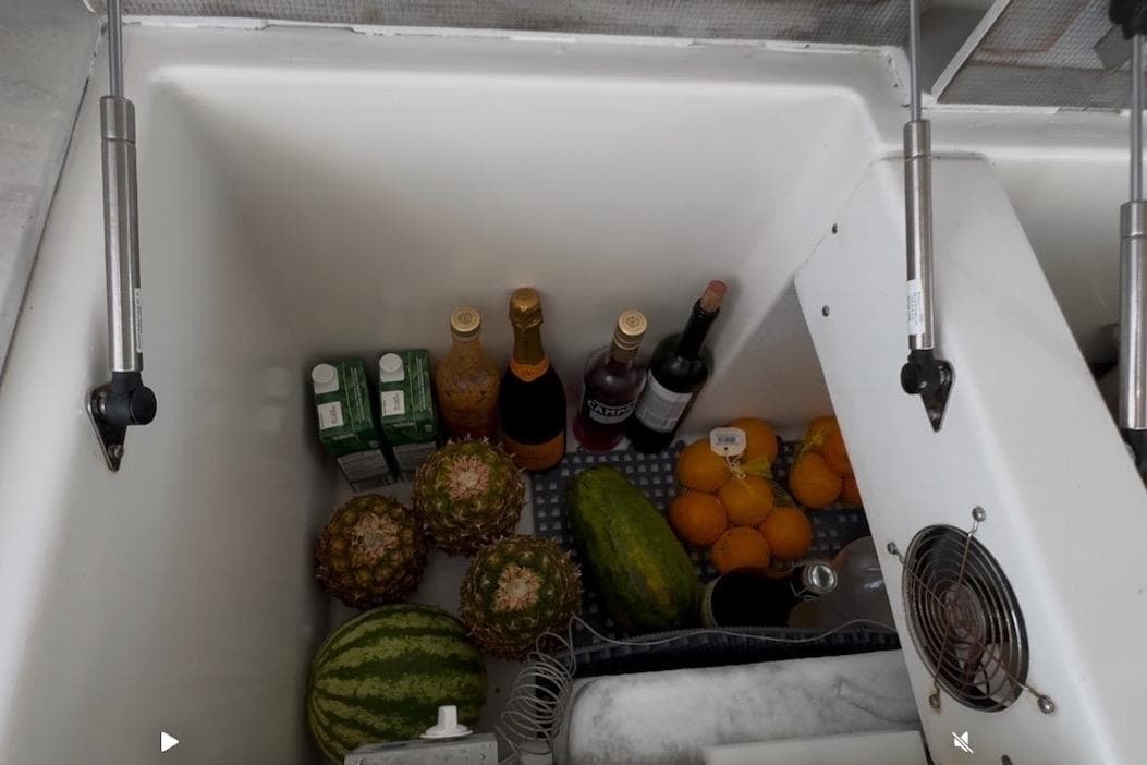 Refrigerated storage on Lagoon 46 yacht with fruits, beverages, and cartons, 2023 model.