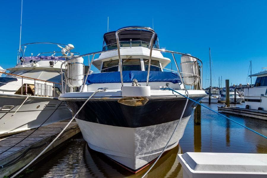 1999 Jefferson Marquessa 56 yacht docked in marina under clear blue sky.