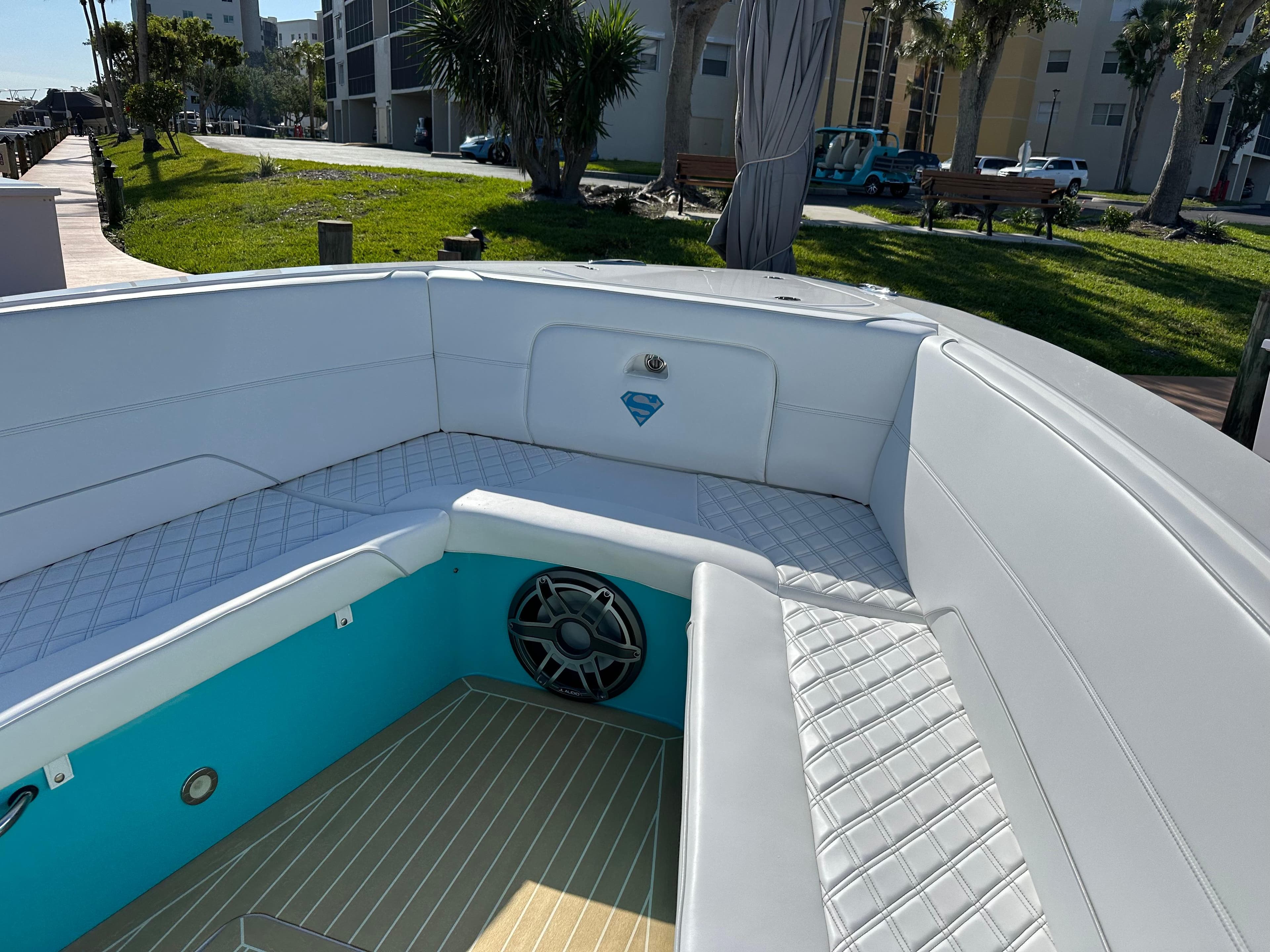2020 Nor-Tech 390 Sport boat interior with white seating and teal accents.