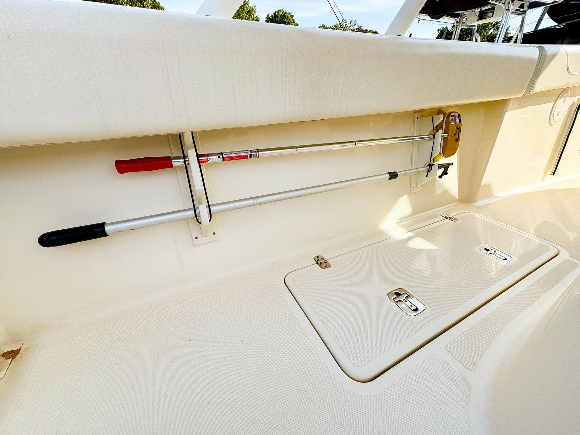 2014 Pursuit ST 310 Sport boat interior with storage compartment and mounted tools.