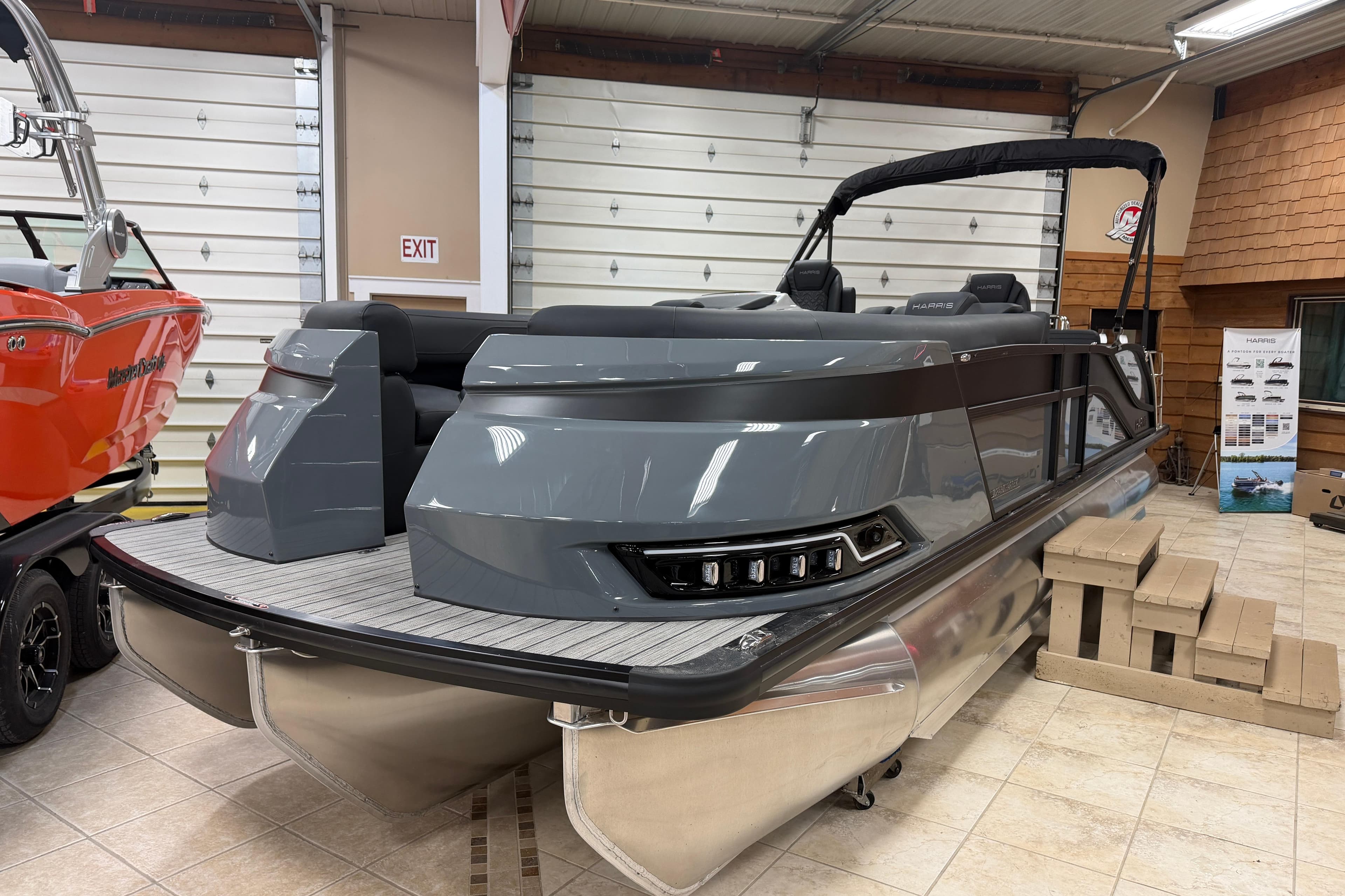 2026 Harris Grand Mariner 250 pontoon boat in showroom, sleek design, gray exterior.