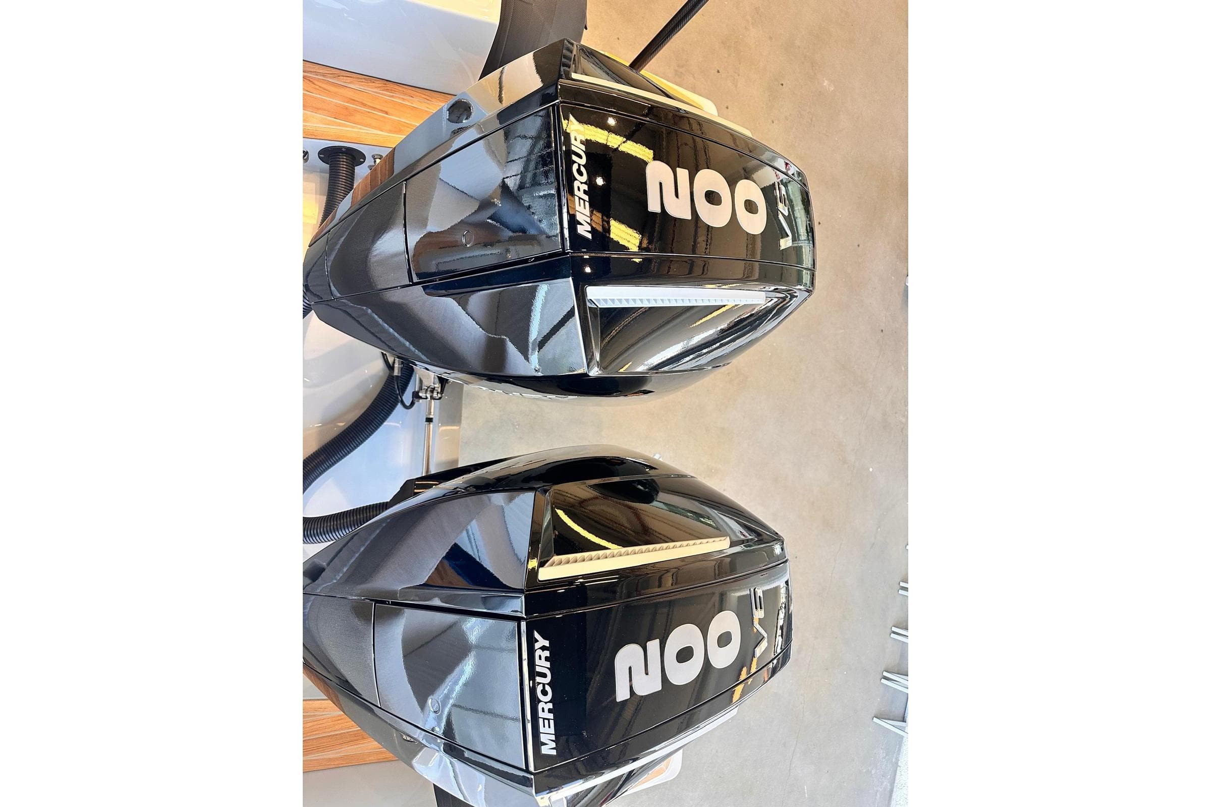 Twin Mercury outboard engines on a 2026 SACS 900 boat, showcasing sleek design.