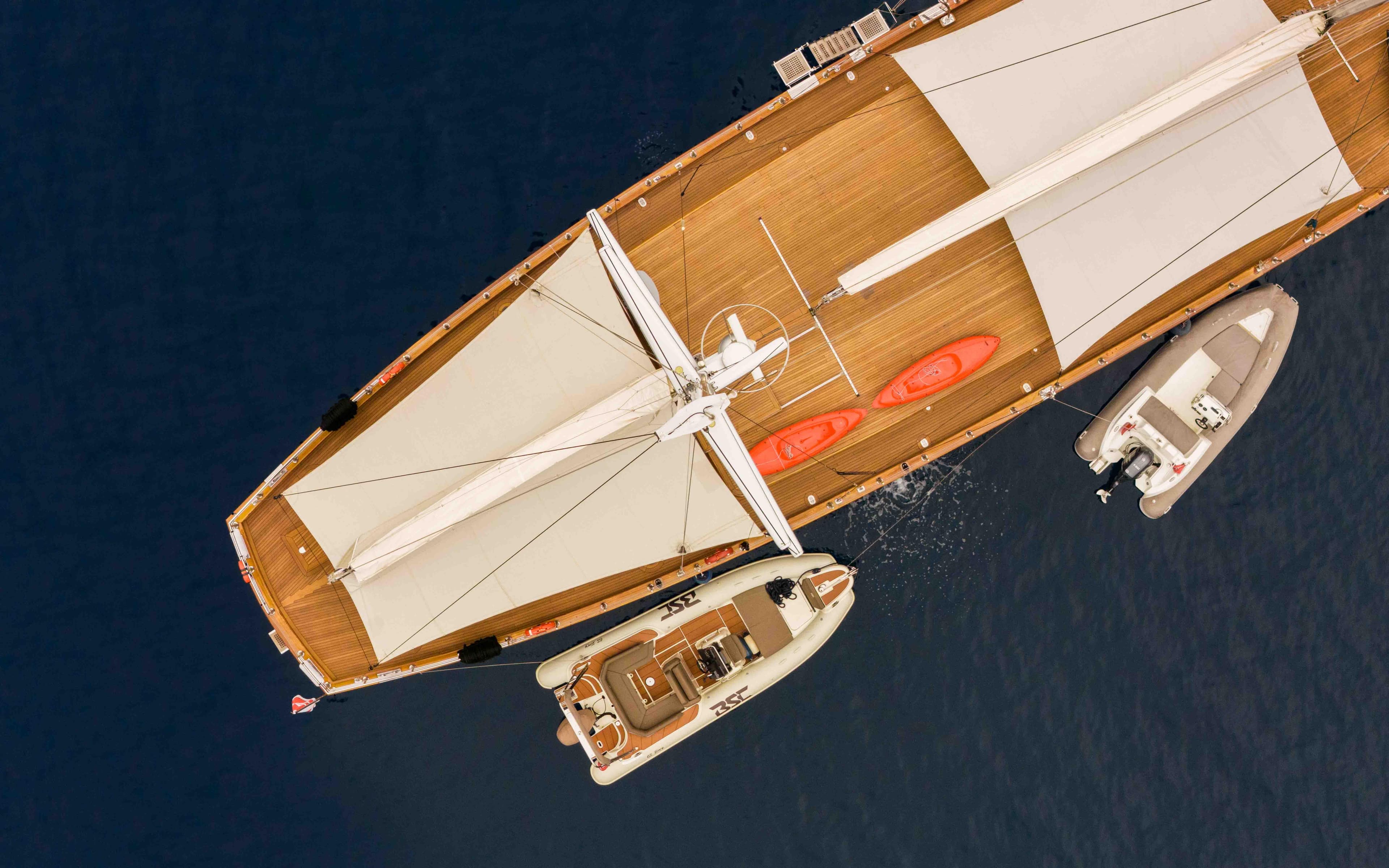 Aerial view of a 2009 Custom Sailing Yacht with two kayaks and a tender boat.