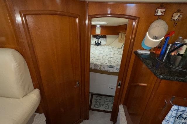 Interior of 2006 Carver 36 Motor Yacht with wood paneling and cozy bedroom.