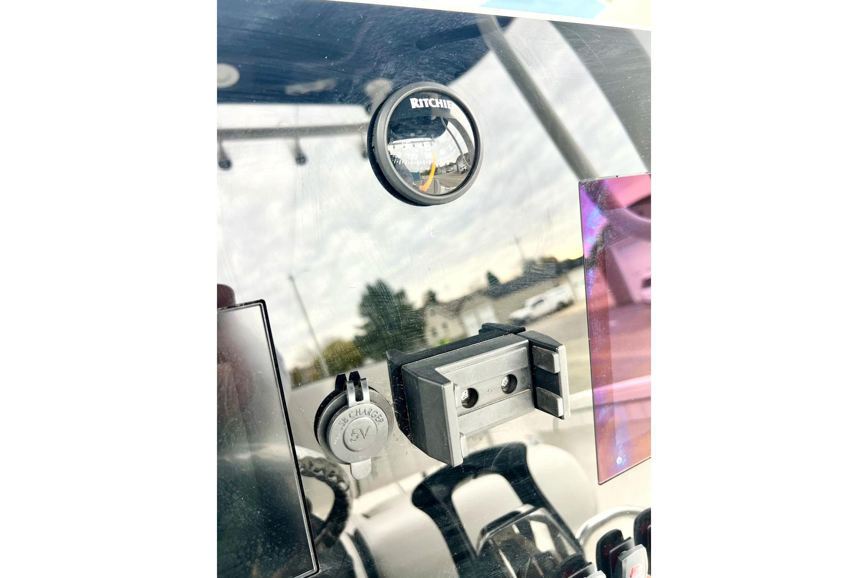 Dashboard of 2022 Yamaha Boats 255 FSH Sport H with compass and USB charger.