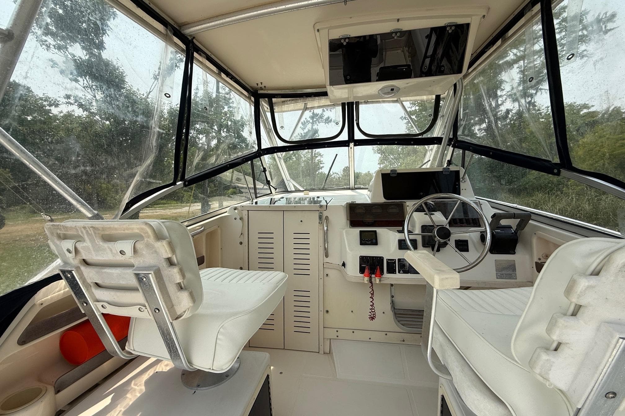 1999 Grady-White Marlin 300 boat interior with steering wheel and seating.