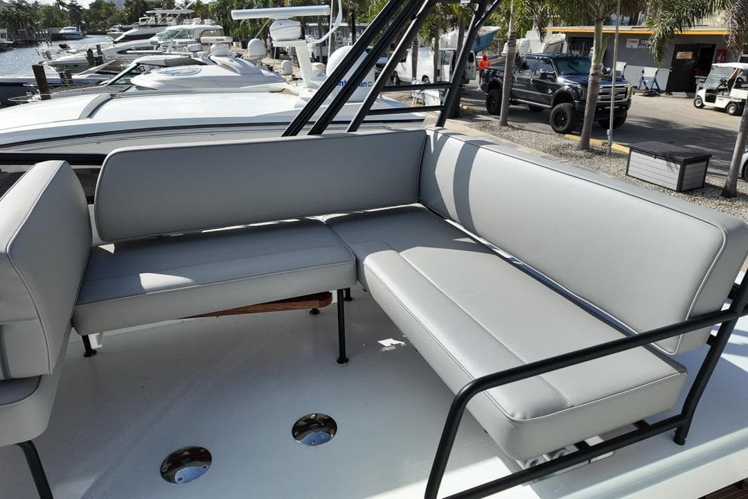 2026 Targa 41 boat seating area with gray cushions, docked near other boats.