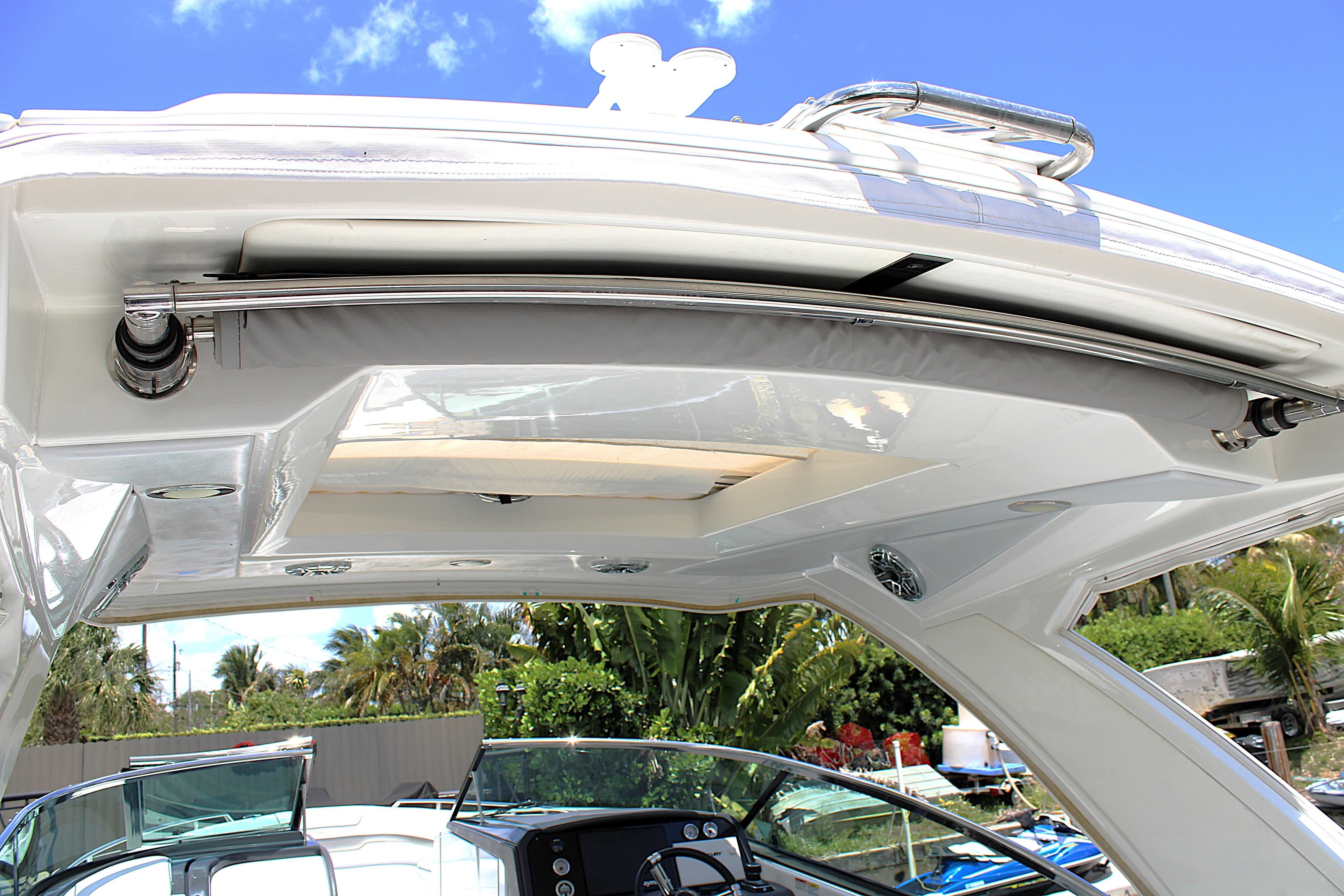 2022 Formula 310 Bowrider OB boat canopy and interior view under clear blue sky.