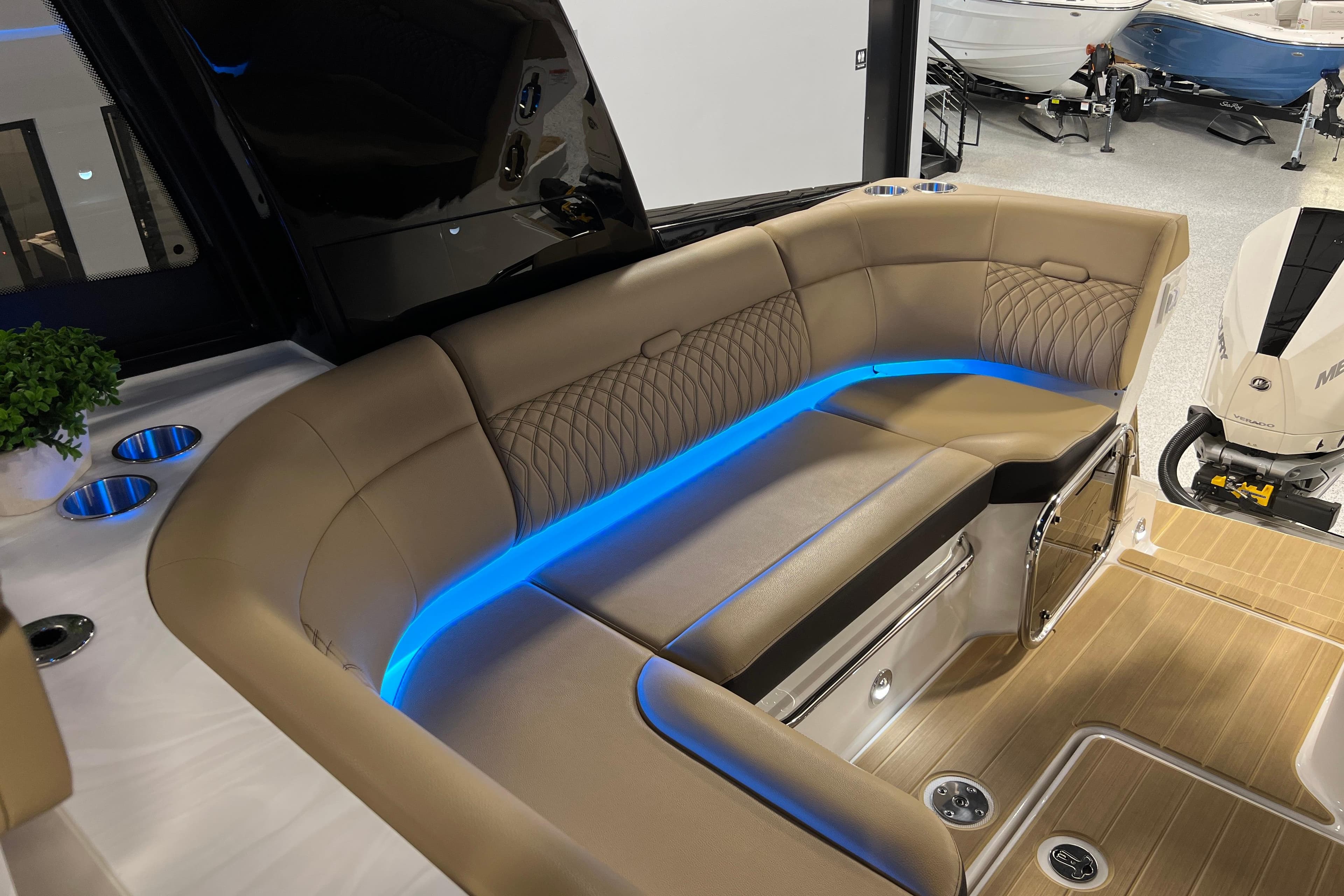 Luxurious seating area on 2025 Sea Ray Sundancer 370 Outboard with ambient blue lighting.