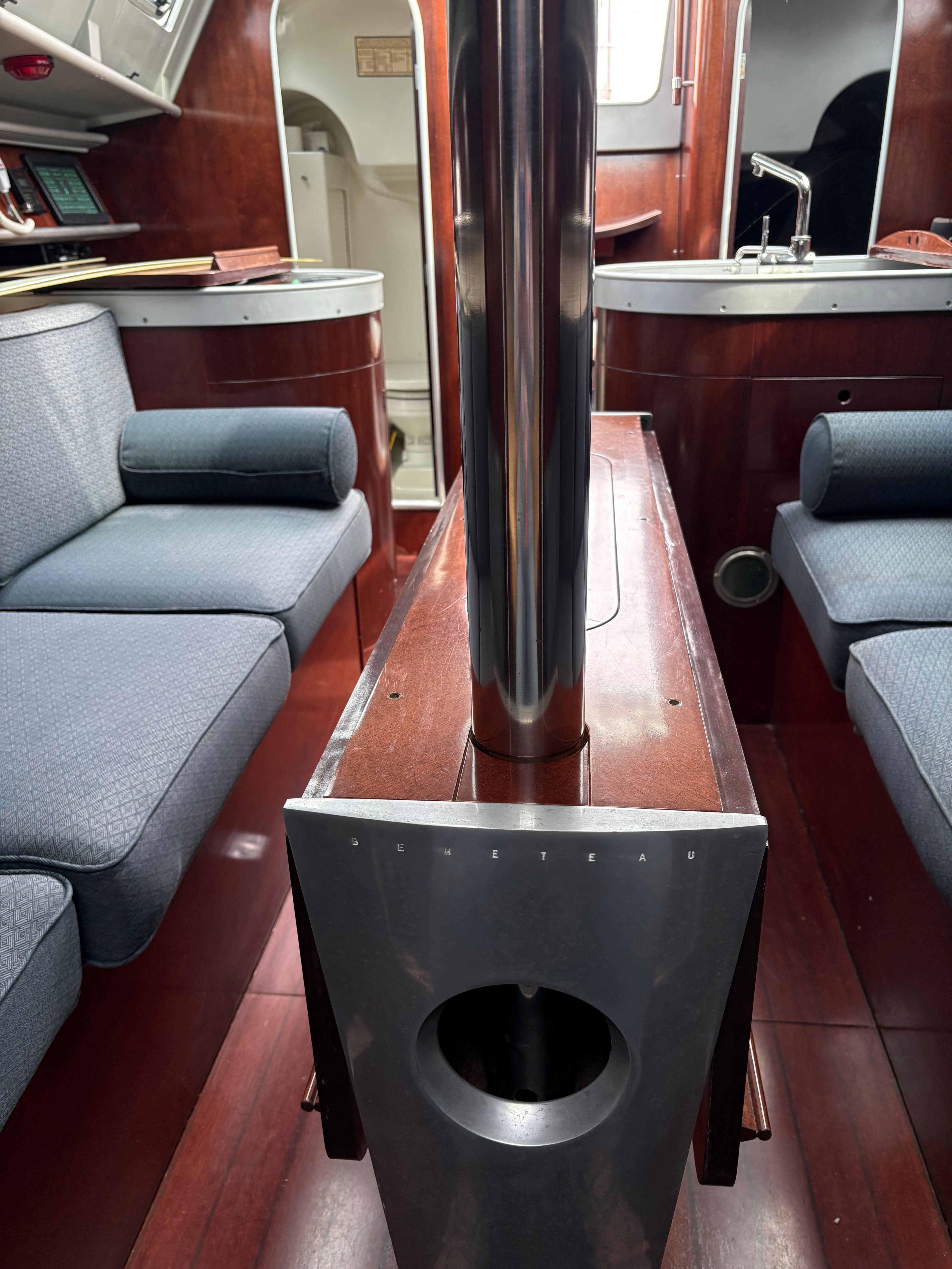 Interior of a 1989 Beneteau 32s5 sailboat with wood and blue upholstery.
