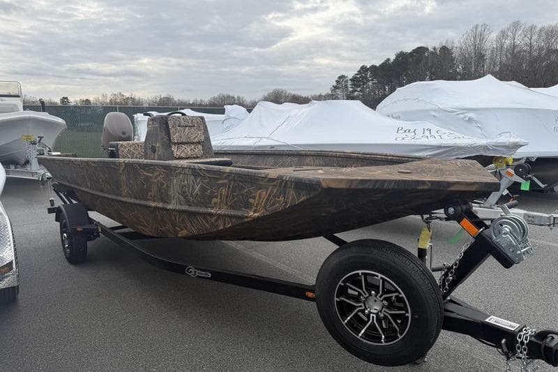 2026 G3 Gator Tough 17 CC boat on trailer, camo design, parked outdoors.