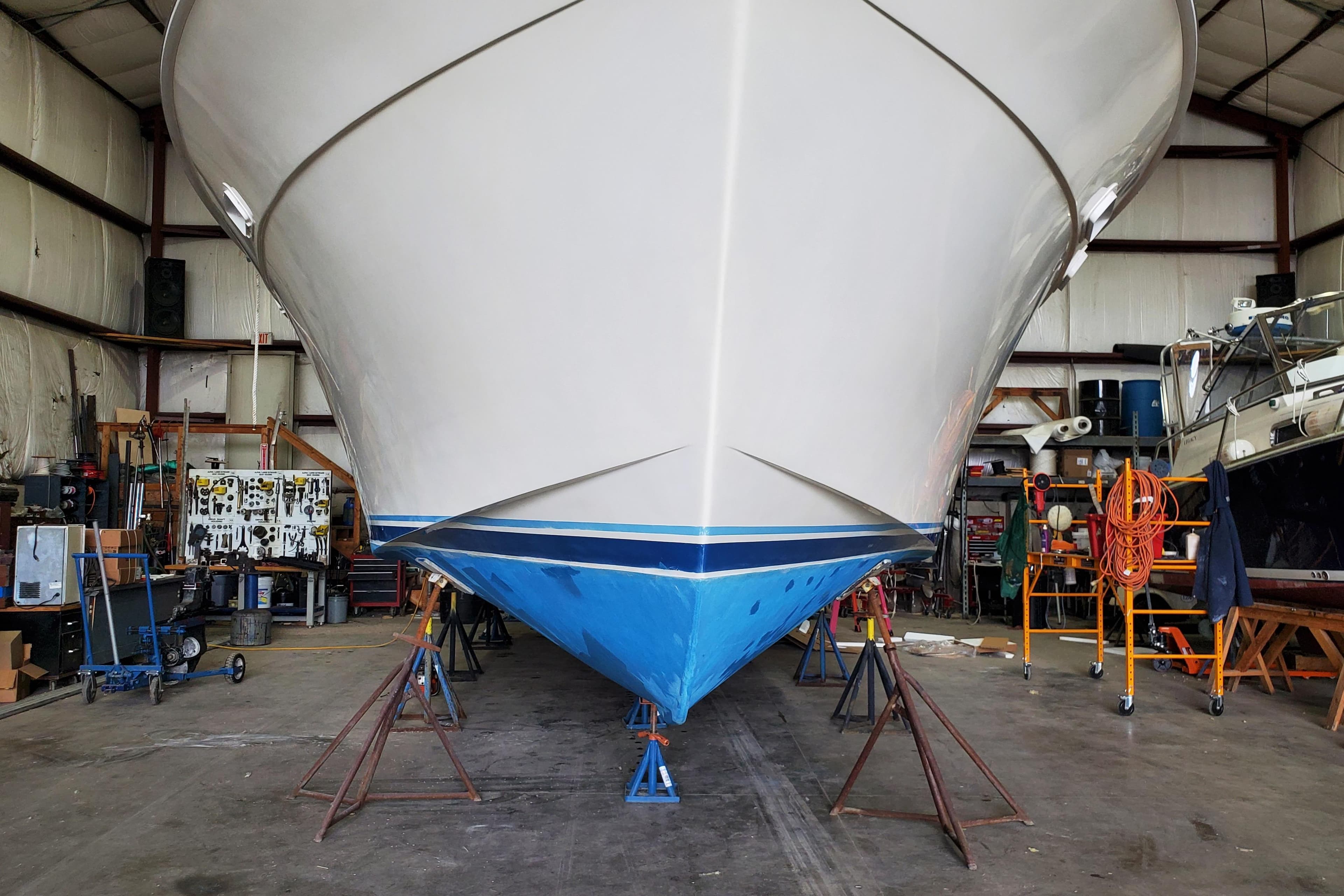 1987 Egg Harbor Convertible 37 boat in a workshop, supported by stands.