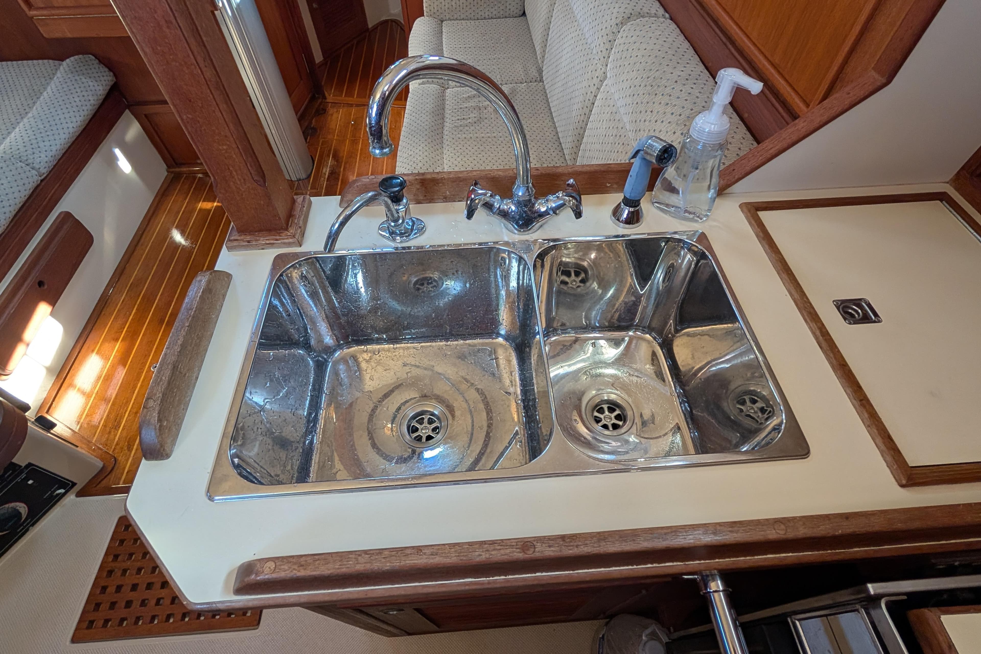 Dual stainless steel sink in 1999 Island Packet 320 yacht kitchen.
