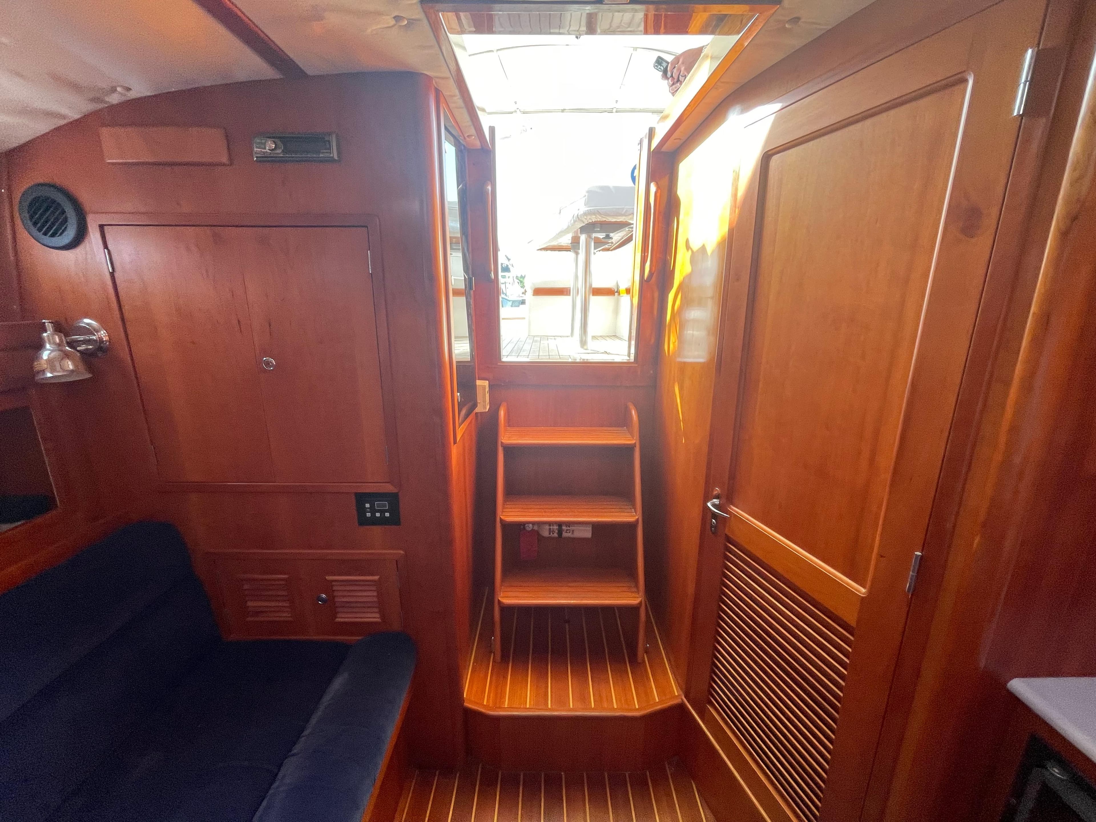 Interior of 1997 Little Harbor WhisperJet 36, featuring wooden cabinetry and seating.