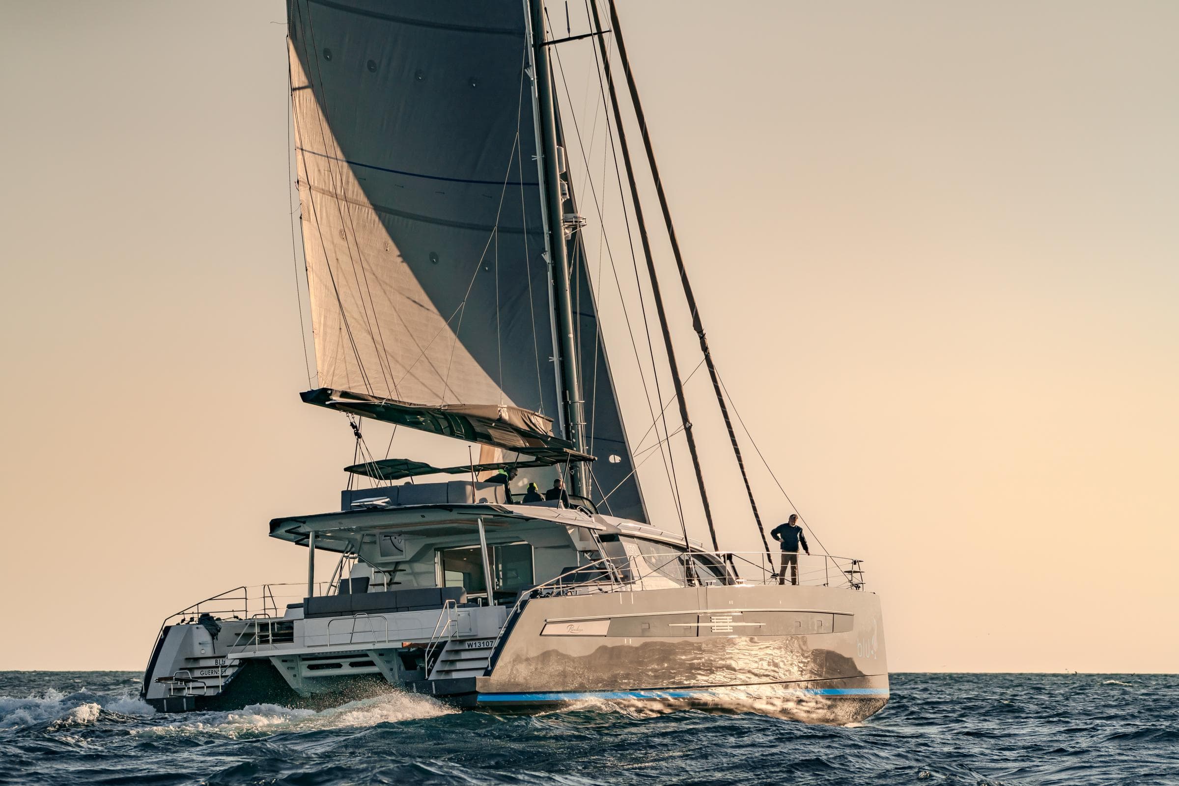 Luxury Privilege Signature 650 catamaran sailing at sunset, 2025 model.