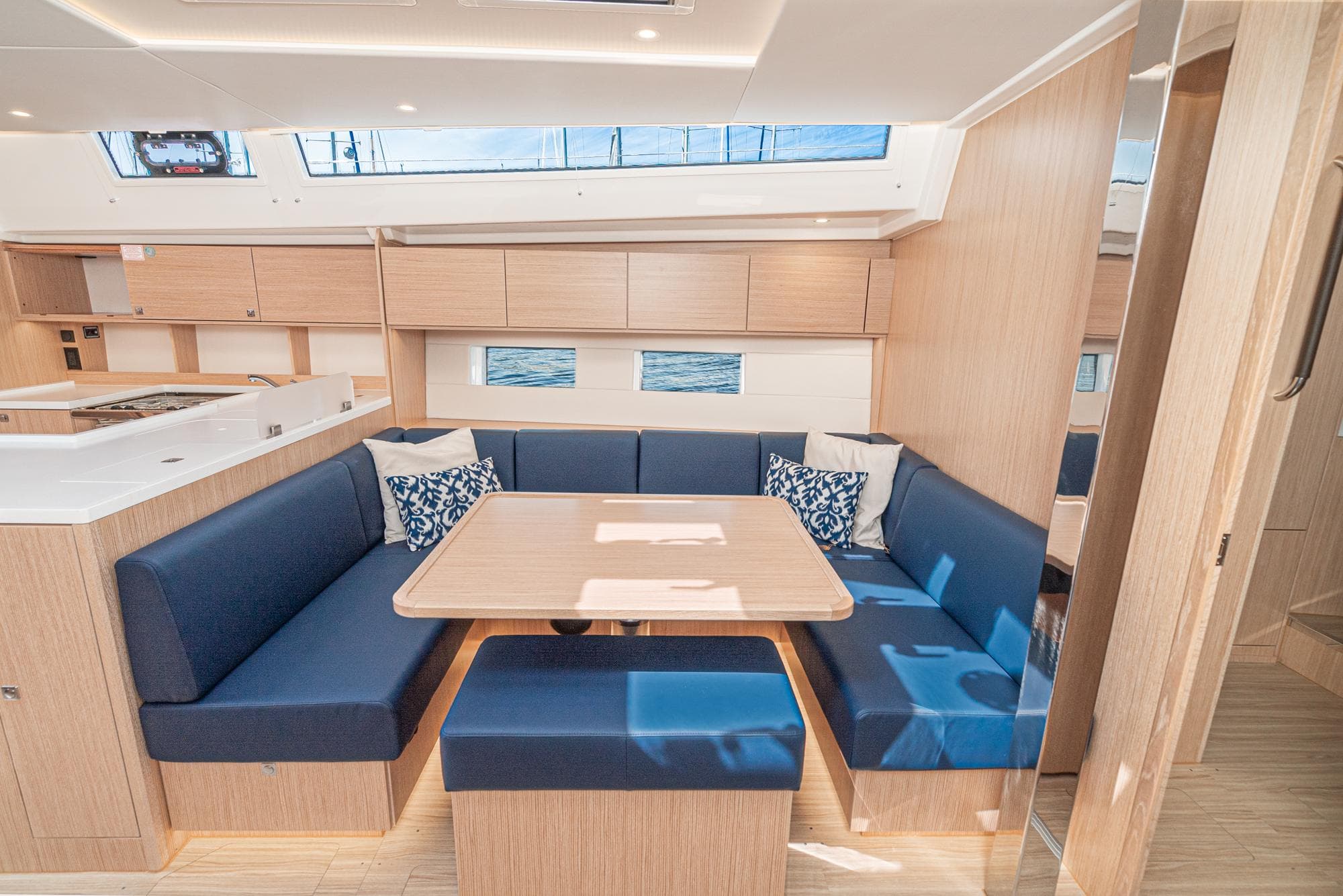 Luxurious interior of 2024 Bavaria C50 yacht with modern seating and dining area.