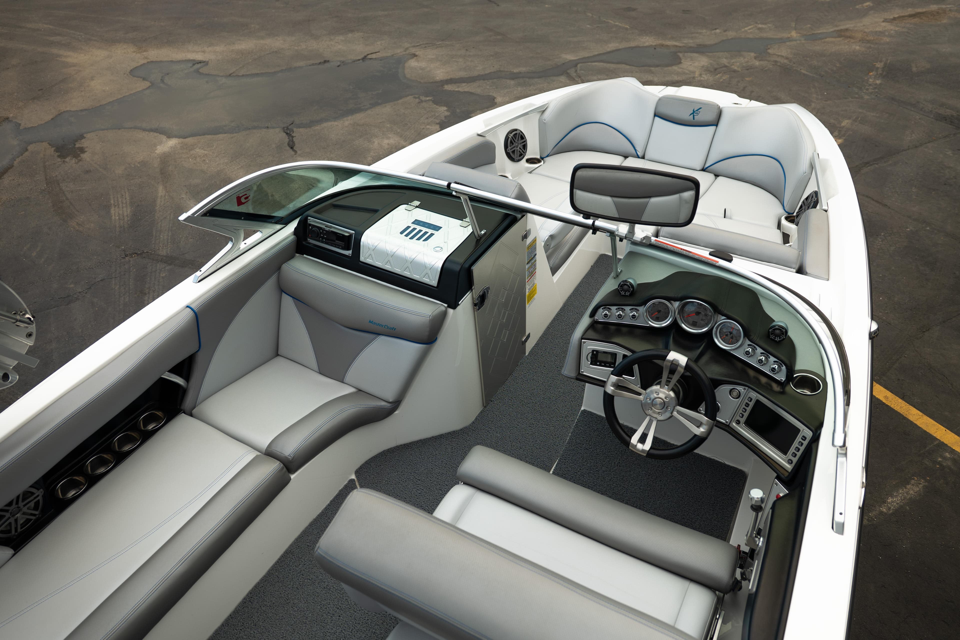 Interior of a 2016 MasterCraft X46 boat, featuring sleek seating and modern dashboard.
