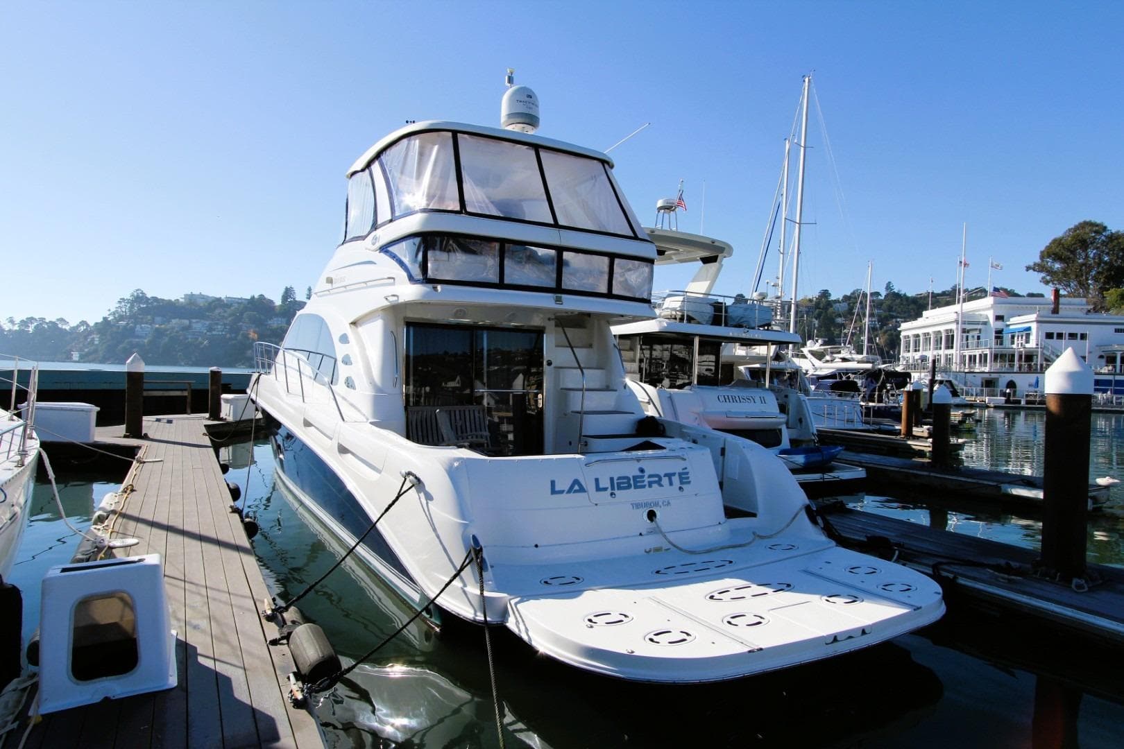 2007 Sea Ray 580 Sedan Bridge yacht docked at marina, sunny day.