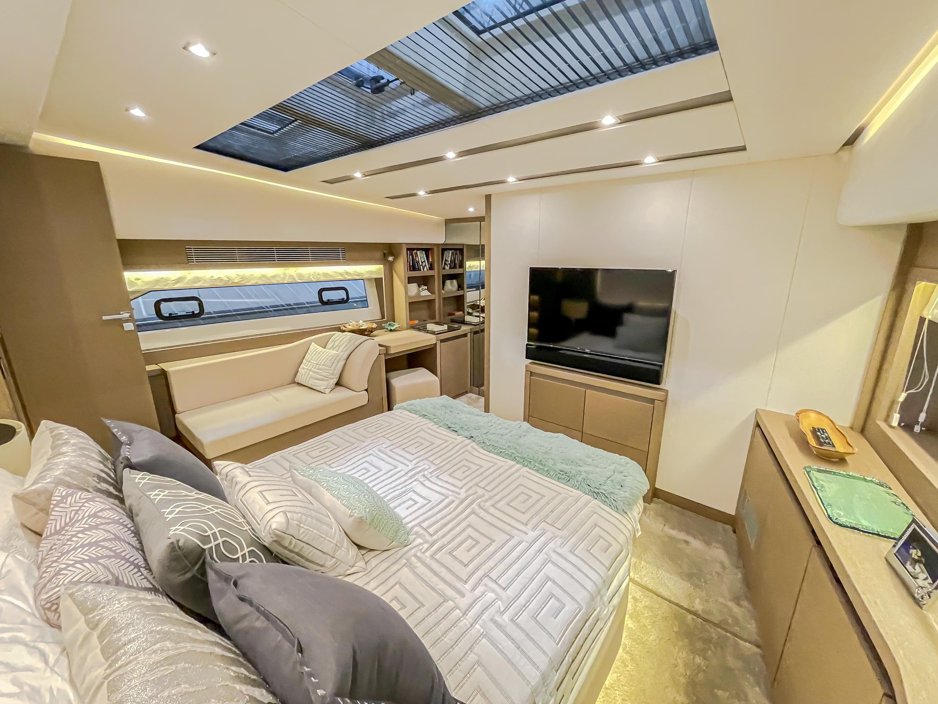 Luxurious bedroom interior of 2016 Prestige 680 Flybridge yacht with skylight and modern decor.