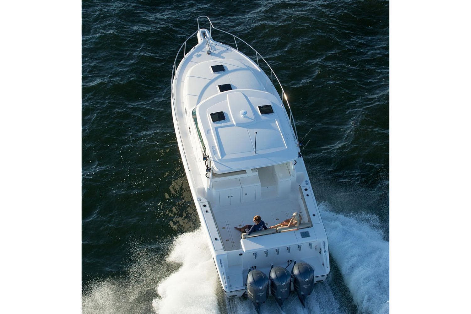 Manufacturer Provided Image: 2019 Pursuit OS 385 Offshore boat cruising on water, aerial view.