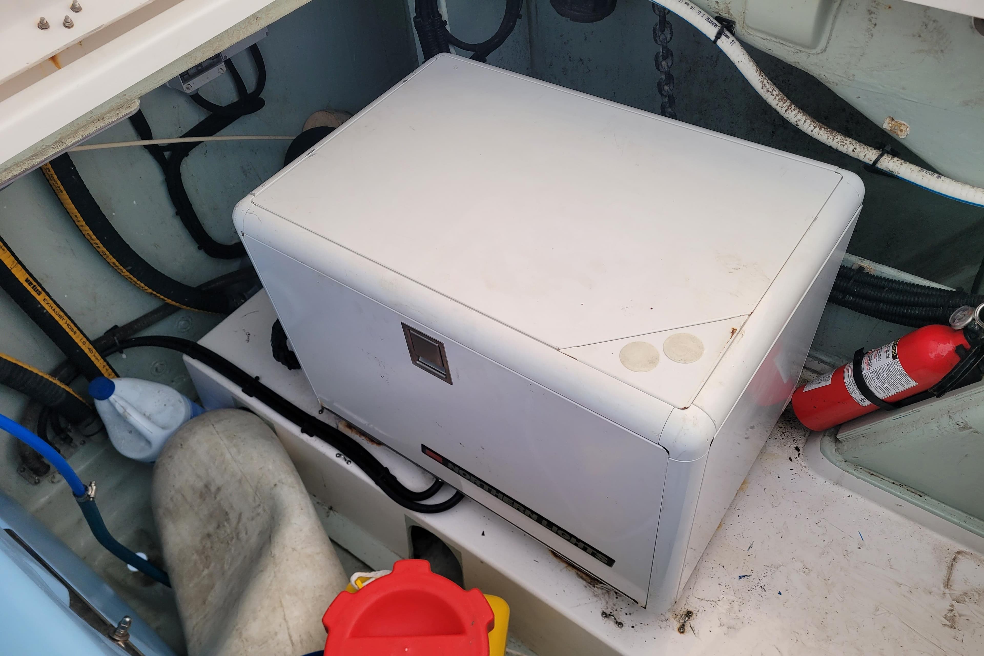 Electrical compartment of a 2018 Leopard 40 boat with fire extinguisher and wiring.