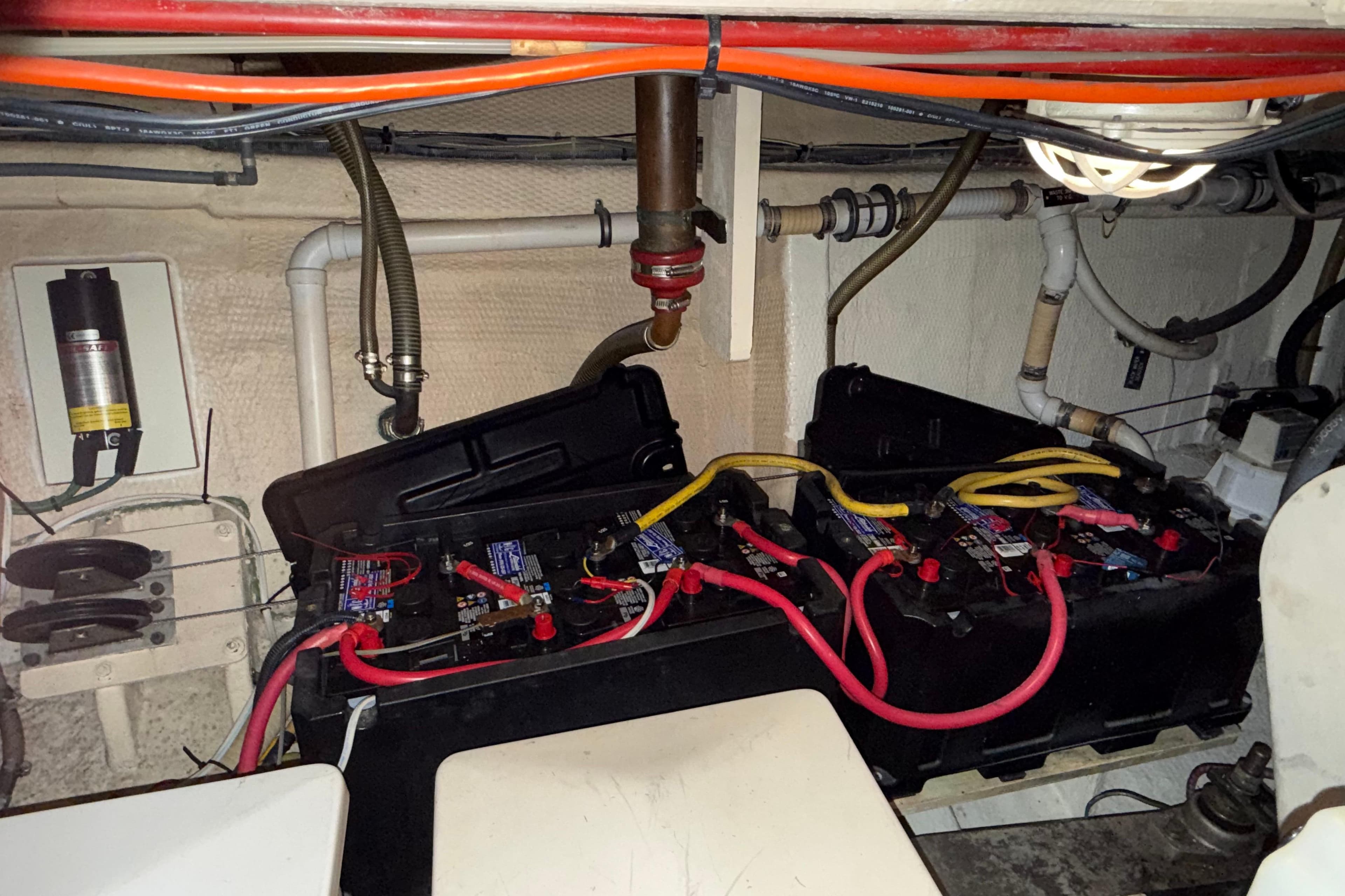Engine room of 1991 Grand Banks 42 Classic with battery setup and wiring.