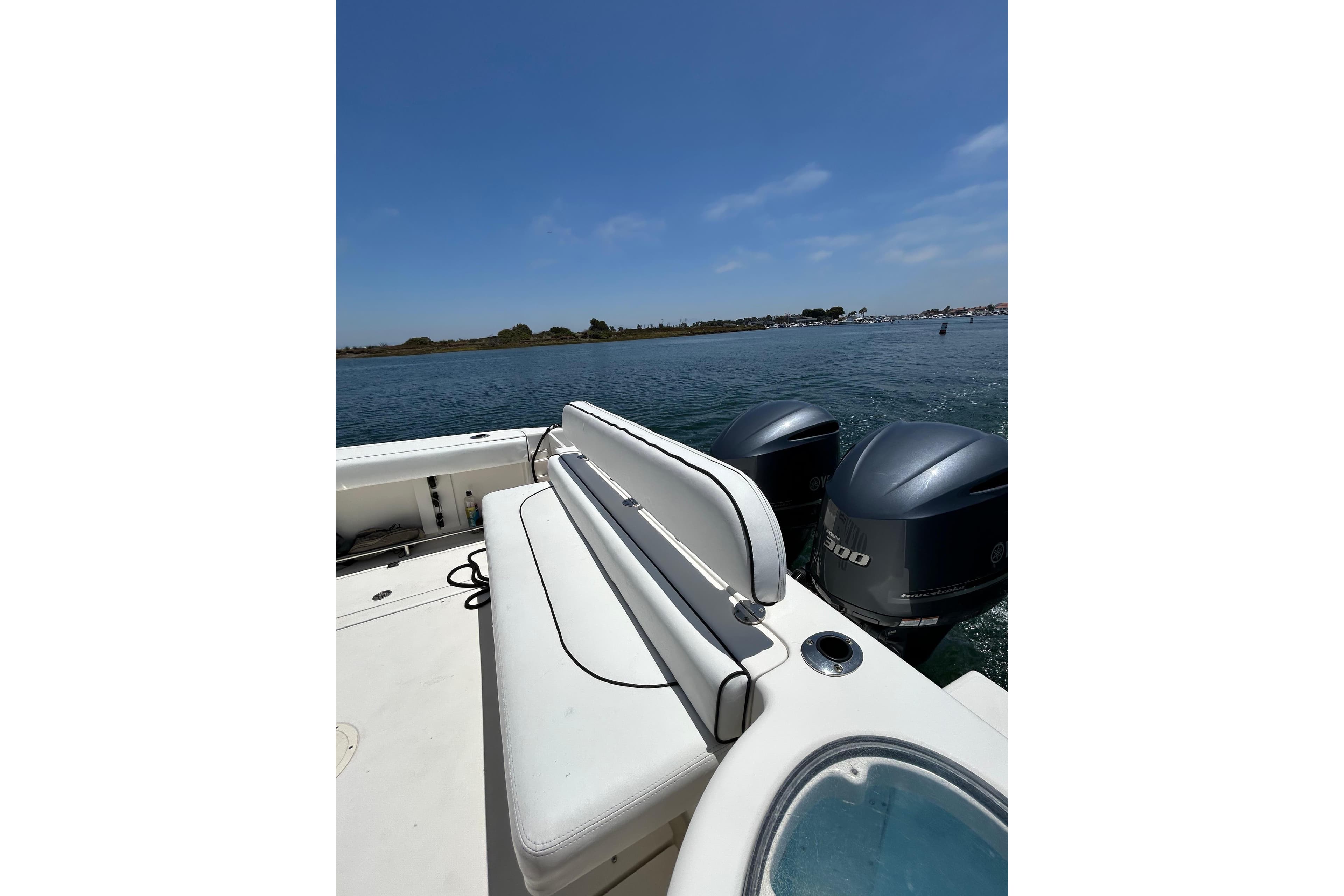 2007 Robalo R305 Walkaround boat with twin engines on a sunny day.