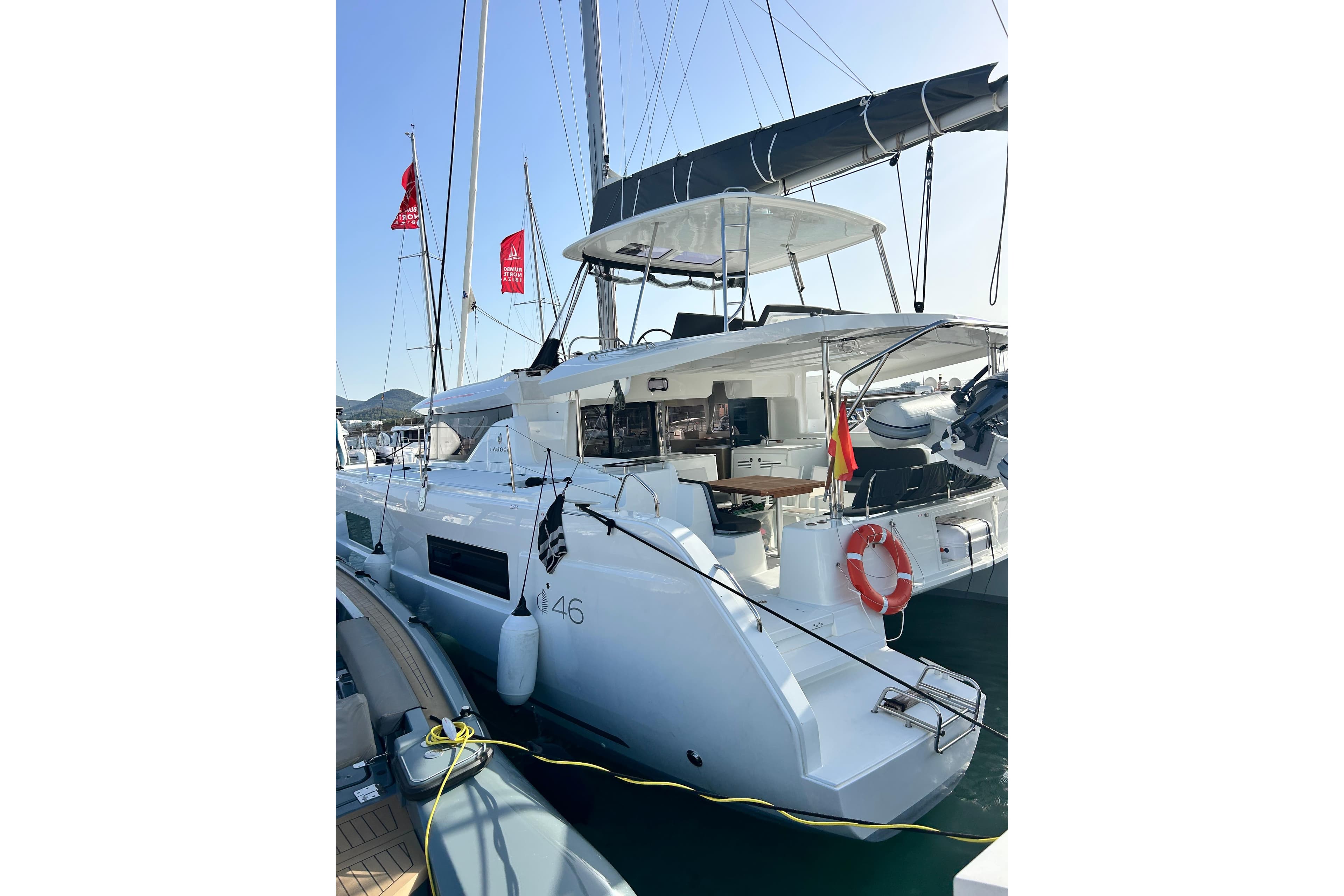 2024 Lagoon 46 catamaran docked, featuring modern design and spacious deck.