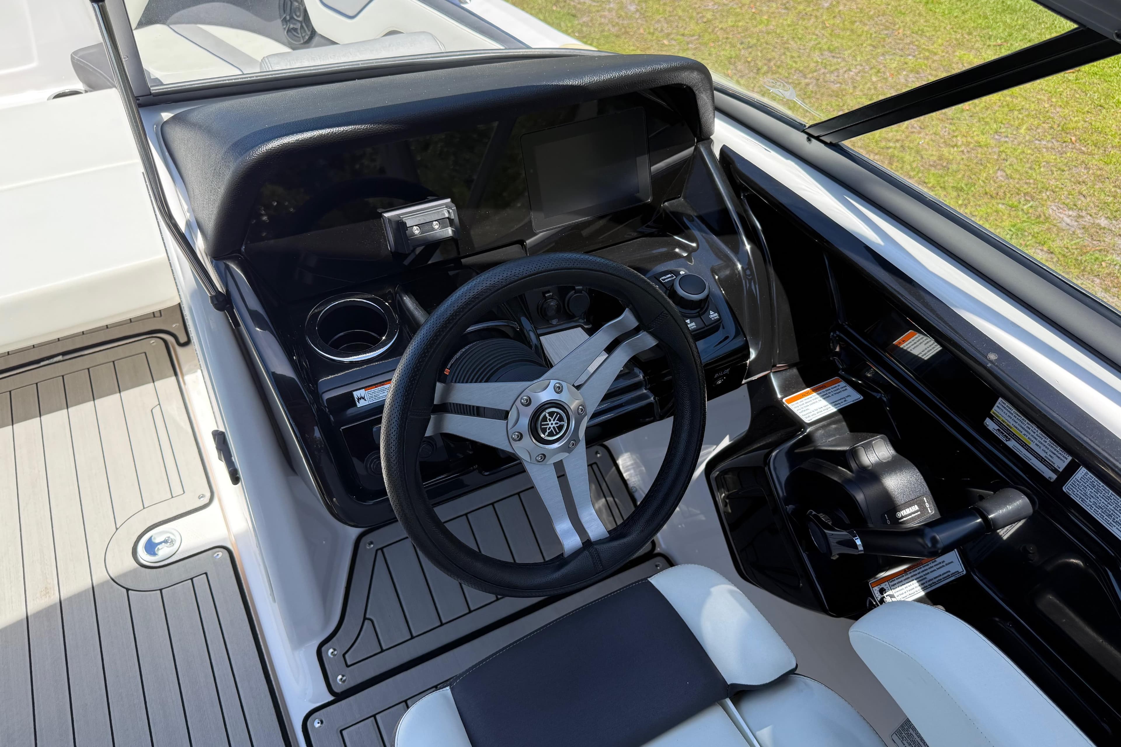 2020 Yamaha Boats 212S cockpit with steering wheel and control panel.