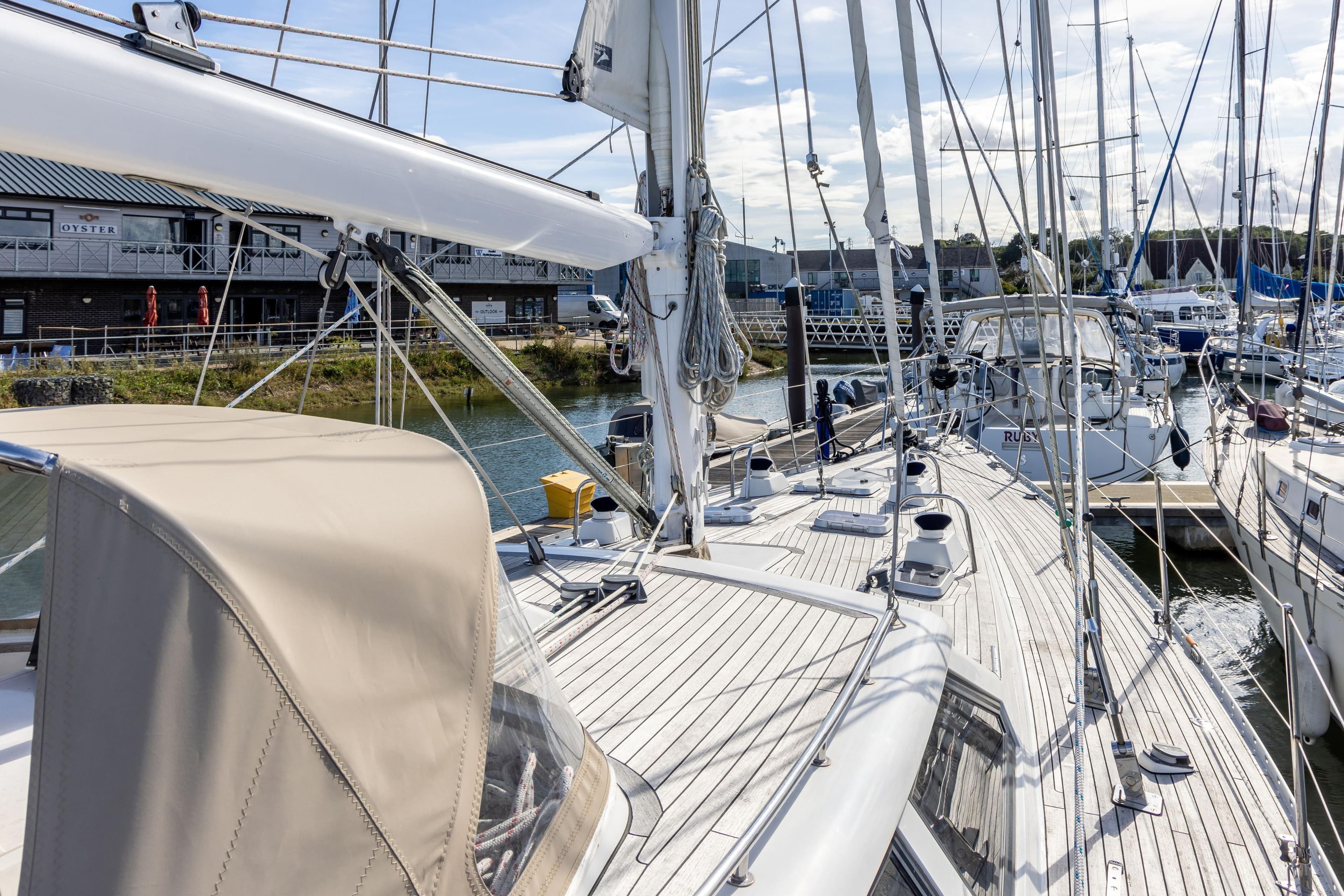 Sailing yacht Oyster 55, 1994 model, docked at marina with clear skies.