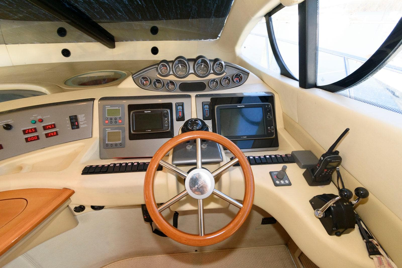 Cockpit of 2005 Azimut 50 Flybridge yacht with steering wheel and navigation instruments.