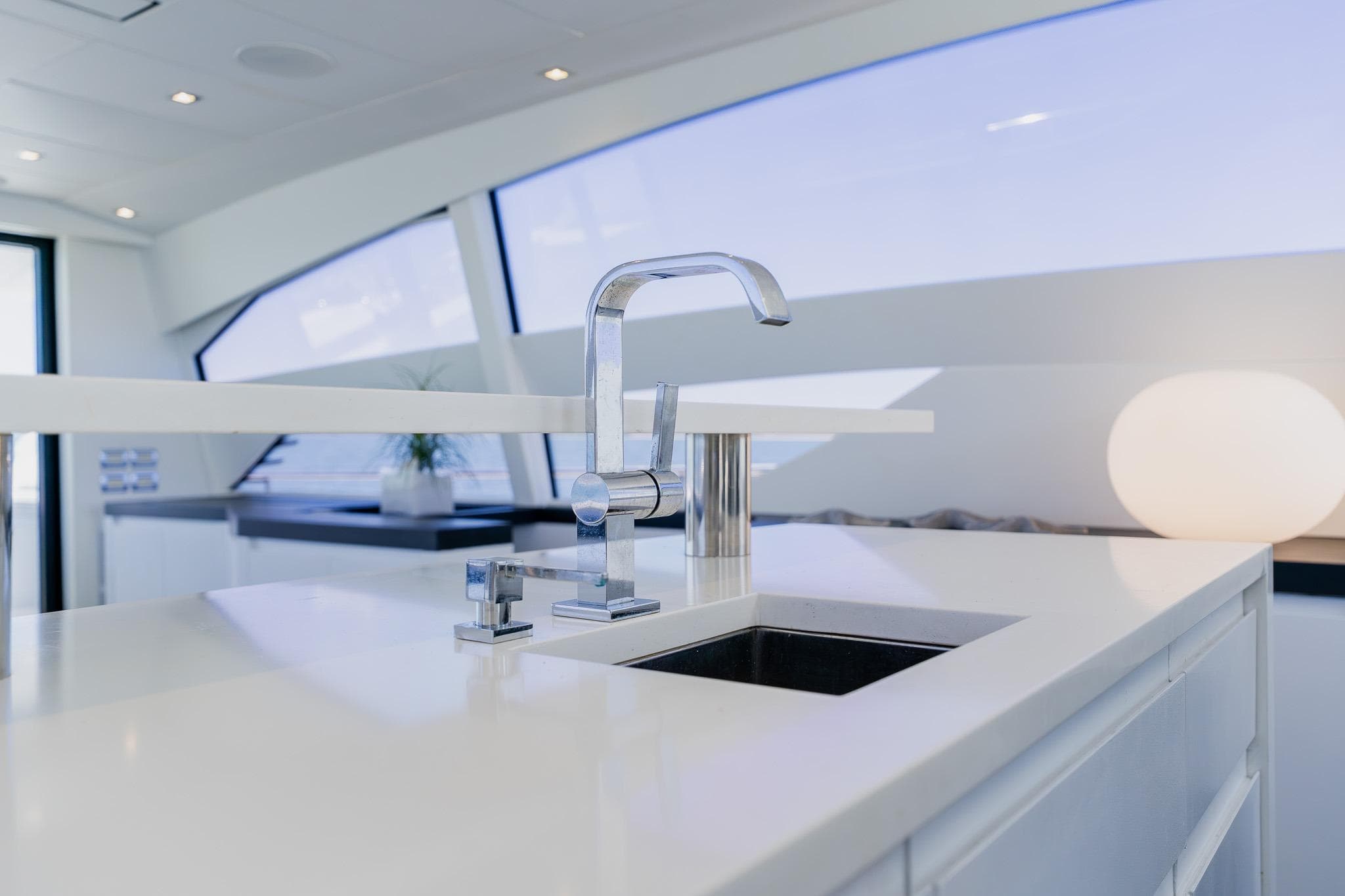Modern kitchen sink on 2010 Pershing 80 yacht, featuring sleek design and elegant fixtures.