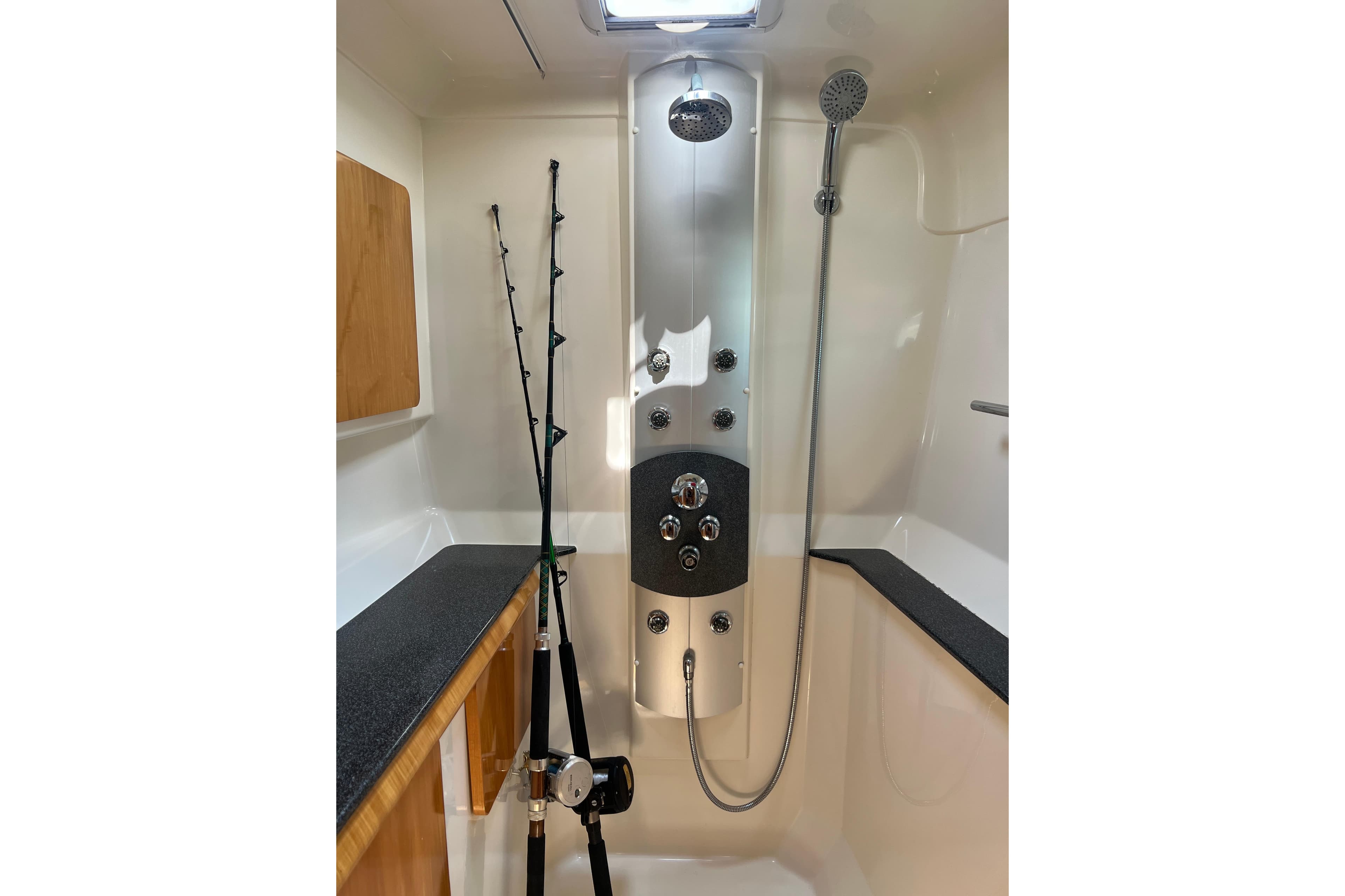 Luxury shower area in 2007 Privilege 495 yacht with fishing rods.