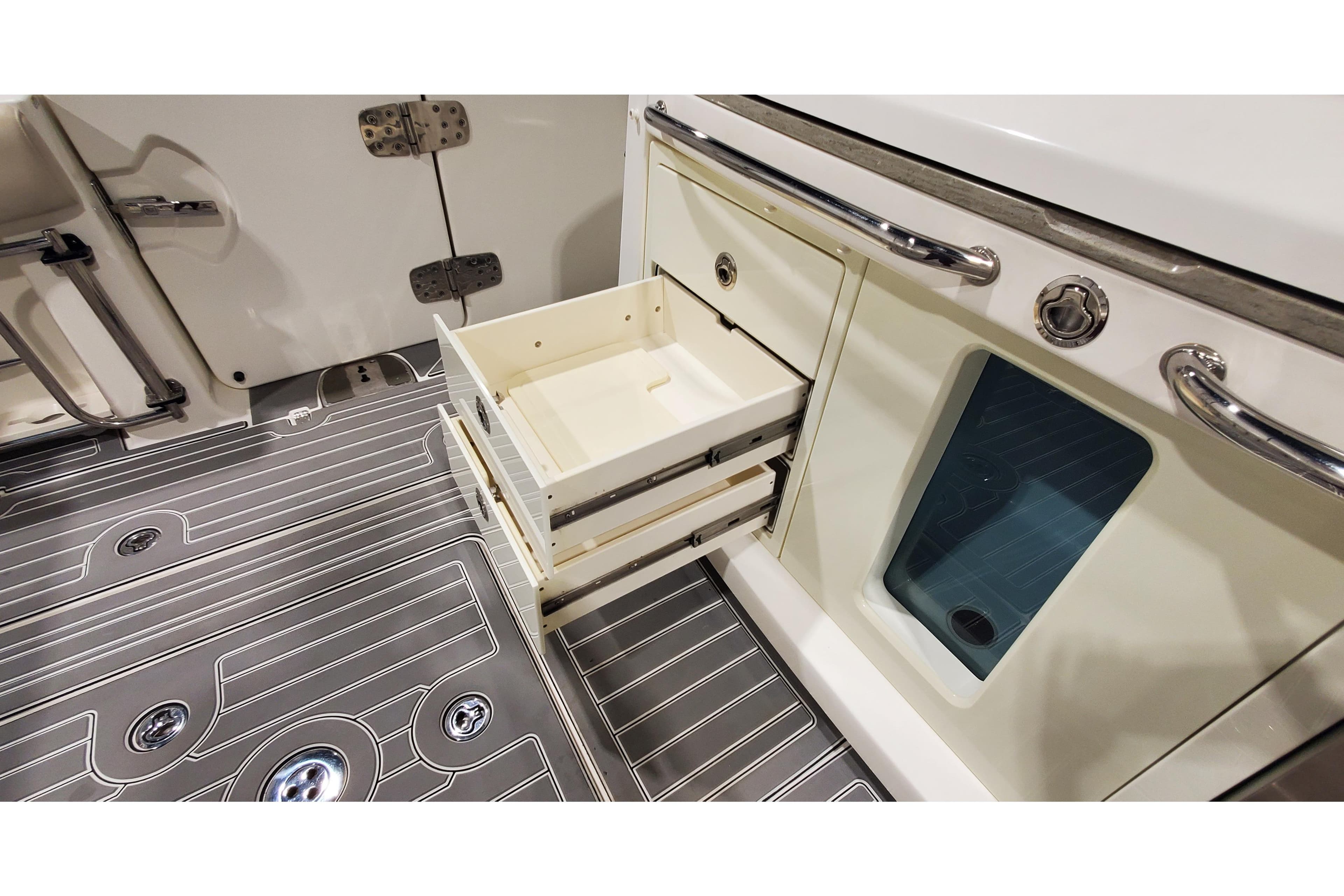 2016 Boston Whaler 420 Outrage interior with open storage drawers and sleek flooring.