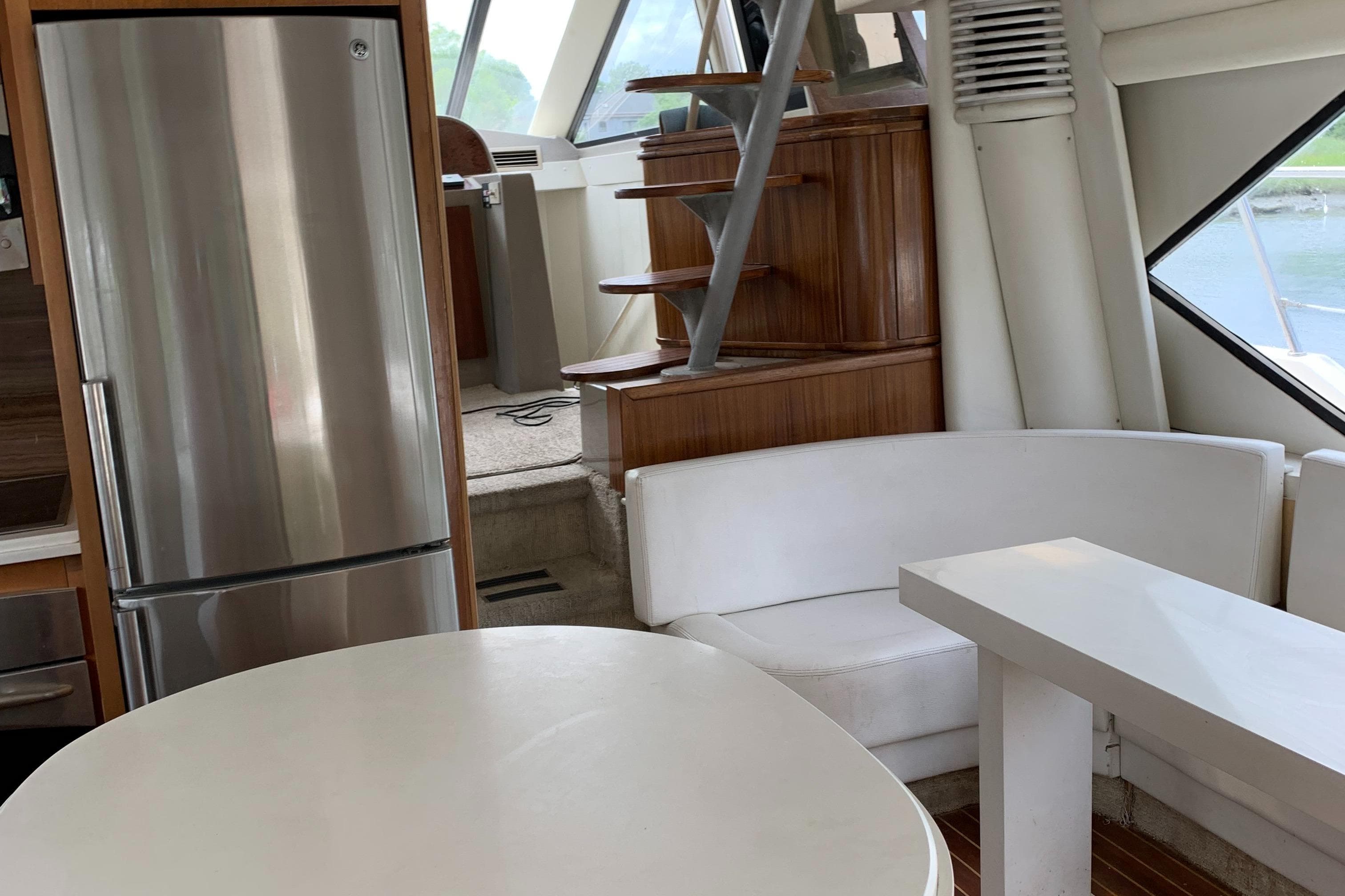 Interior of 1999 Bayliner 5788 Pilot House Motoryacht with modern kitchen and seating area.