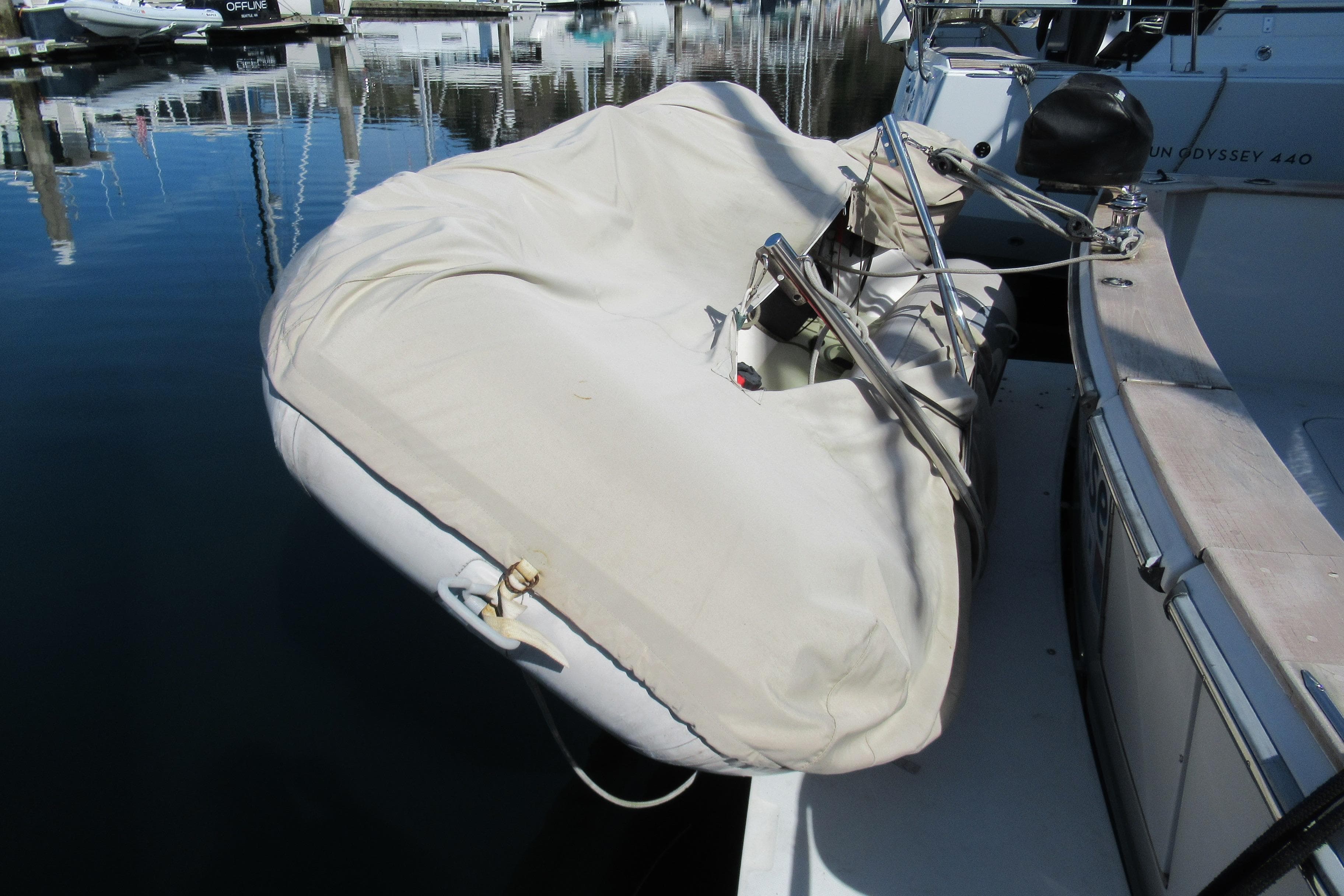 Covered dinghy on a 1988 Chris-Craft 392 Commander yacht at a marina.