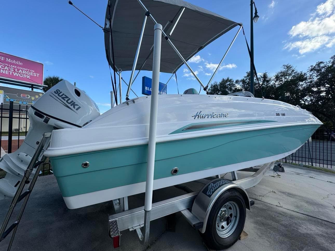 2024 Hurricane SunDeck Sport 188 OB boat on trailer with Suzuki outboard motor.