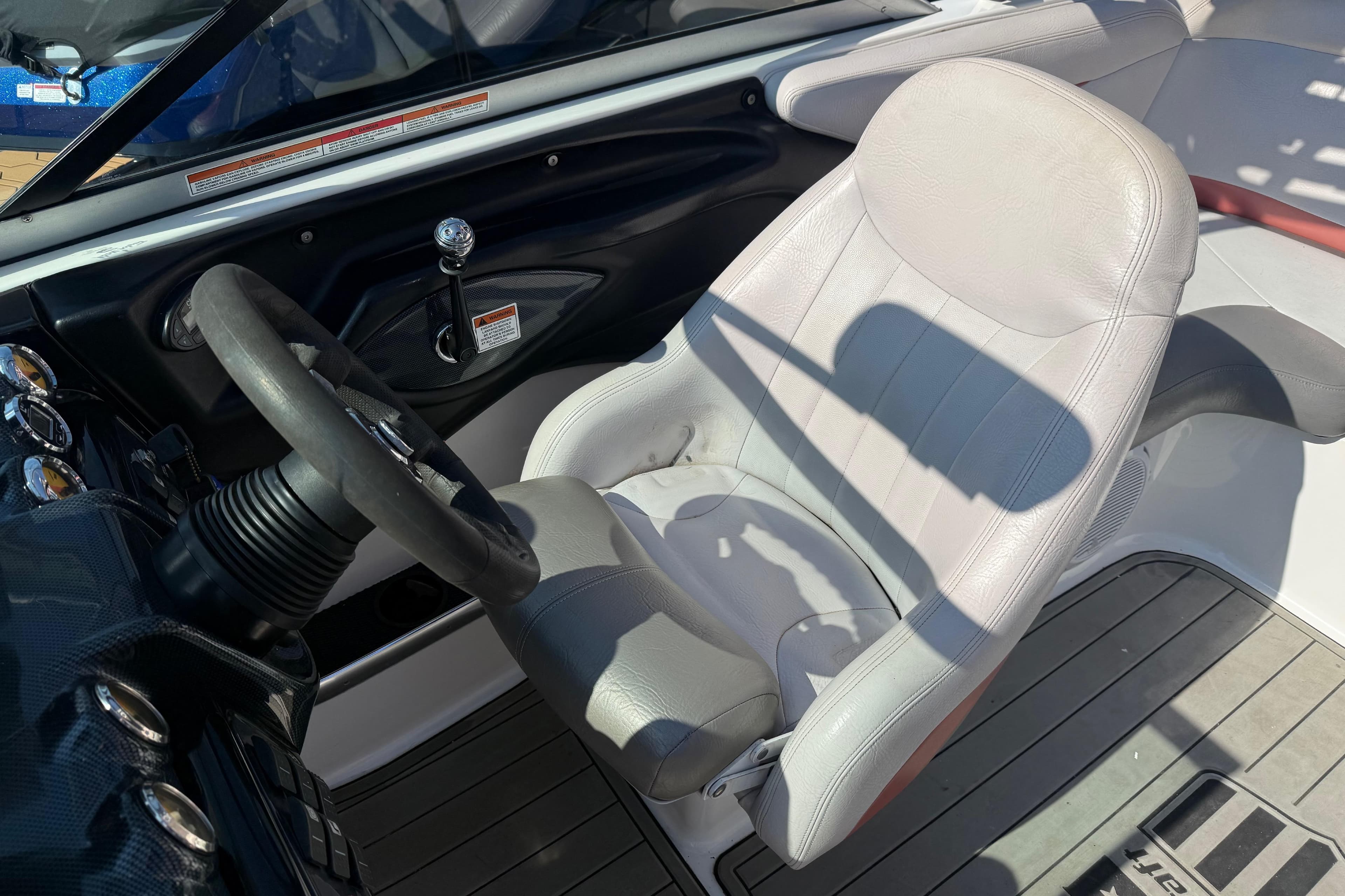 2005 MasterCraft XStar boat interior with steering wheel and captain's seat.